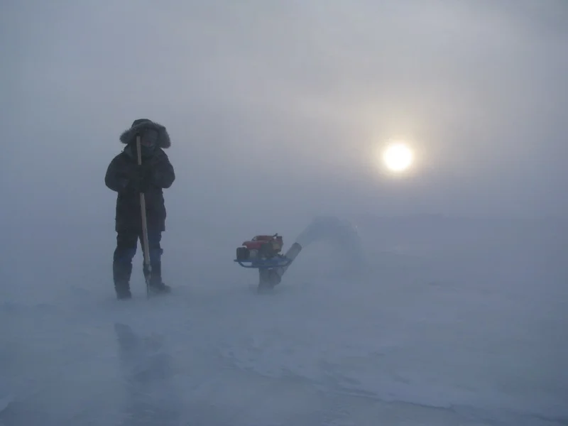 2009 Lake El’gygytgyn, Chukotka, Eastern Russia. Monitoring one of the “flood” pumps used for thickening the lake ice sheet. The ice covering on the lake had to be thicker than the natural process had made it so that it could sustain the weight of the drilling platform and associated equipment.