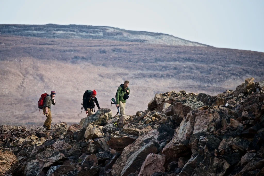 Glacial geologists Maggie Jackson (left), Lauren Farnsworth (center) and Gordon Bromley (right) hiked long miles over bouldery terrain every day, in search of ideal glacial features to be sampled for cosmogenic surface exposure dating. Dates on glacial landforms help to clarify how the Greenland Ice Sheet and local ice caps responded to past climate change in the Thule region. Photo by Alex P. Taylor.