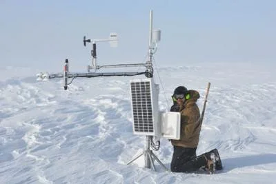 Ben Toth retrieving data card from a weather station. Photo: Robin Davies