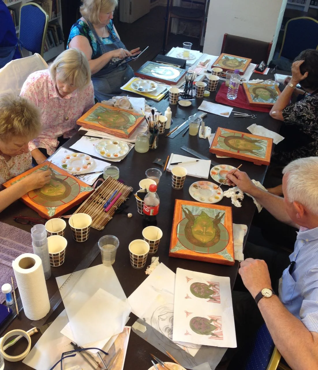 Students in a course paint following step-by-step instructions.