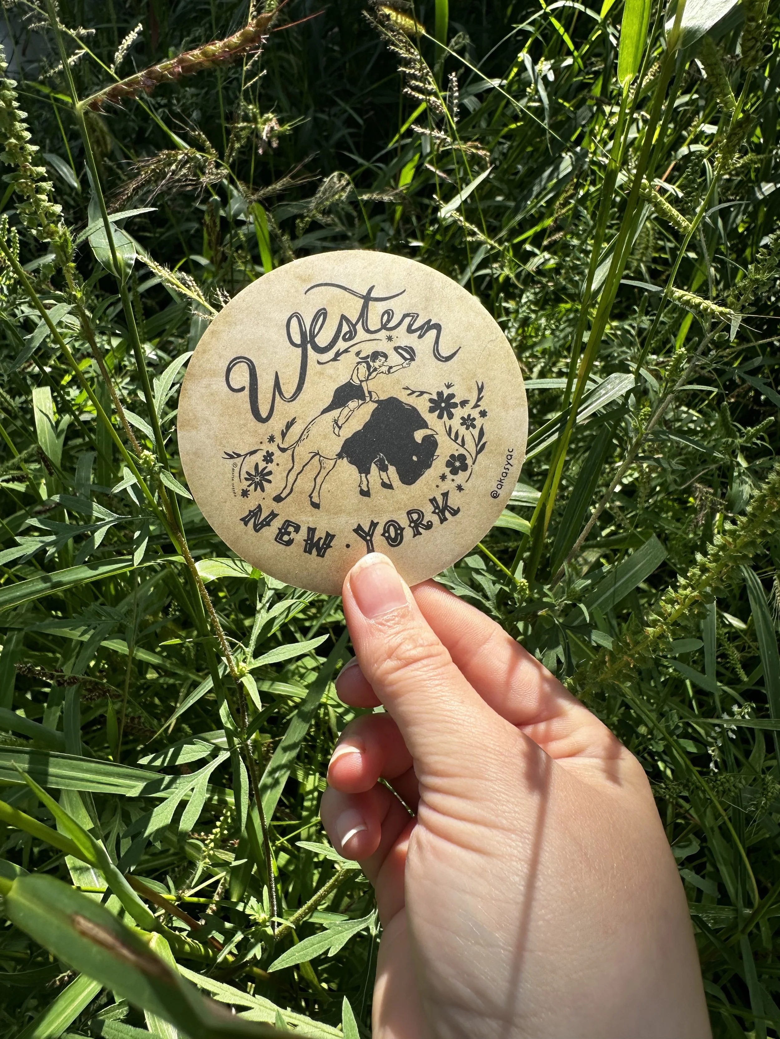 Western NY WNY Sticker in hand in front of grass.jpg
