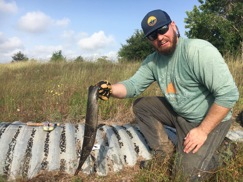  Zach with his first gar on the fly. Judging by his facial expression,&nbsp;we don't share the same sentiments about this fish. 