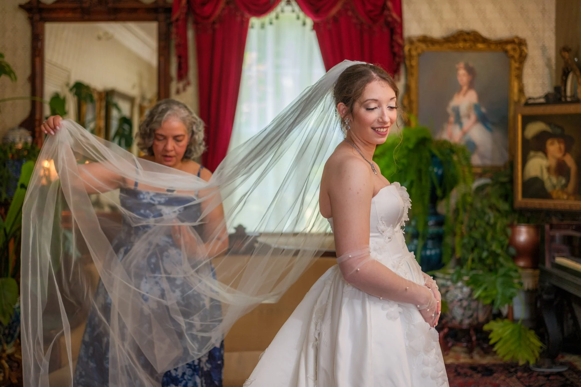 Bride smiling as her veil is adjusted before the ceremony