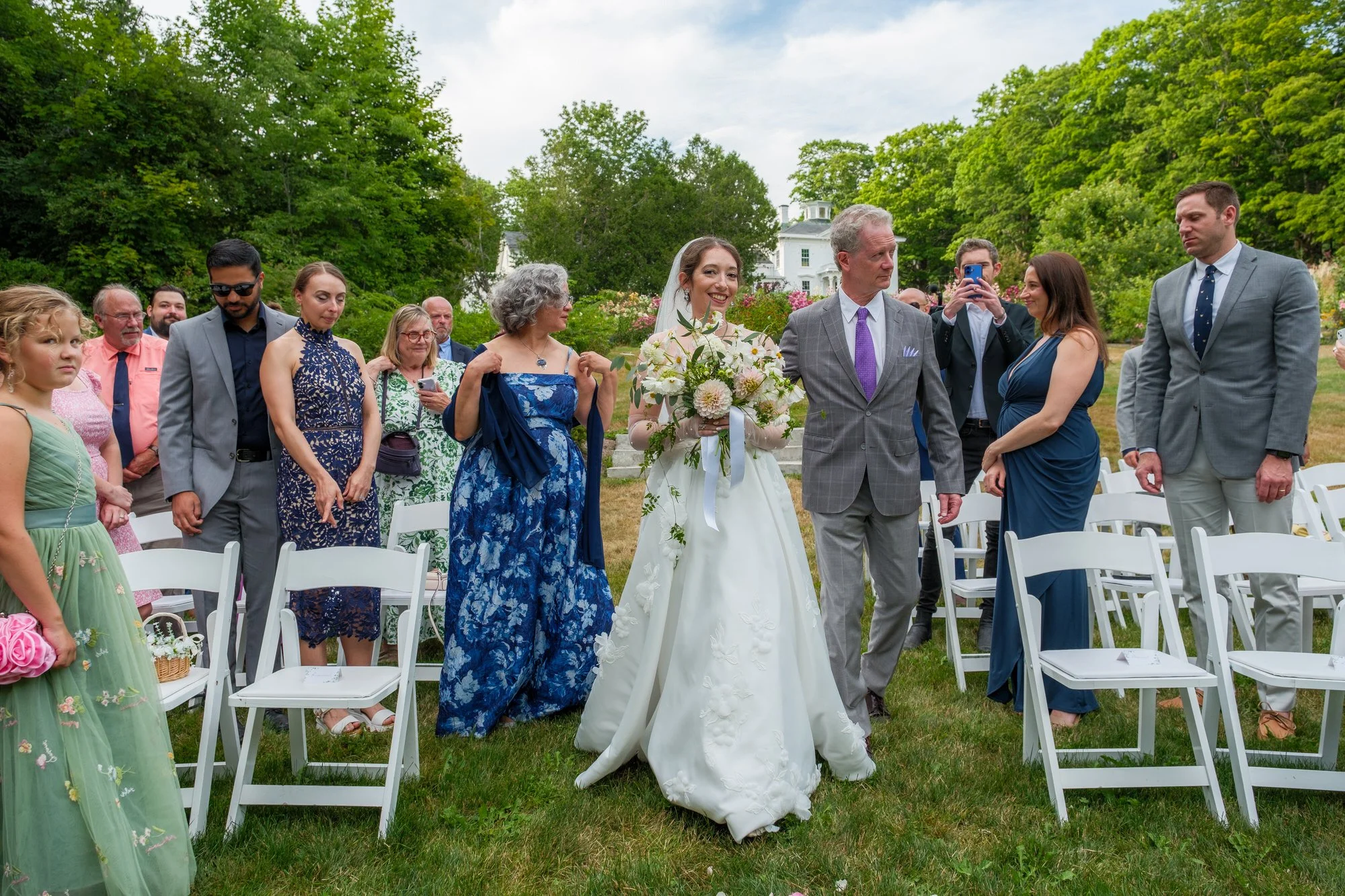 Bride escorted down the aisle at a Belvedere House garden ceremony