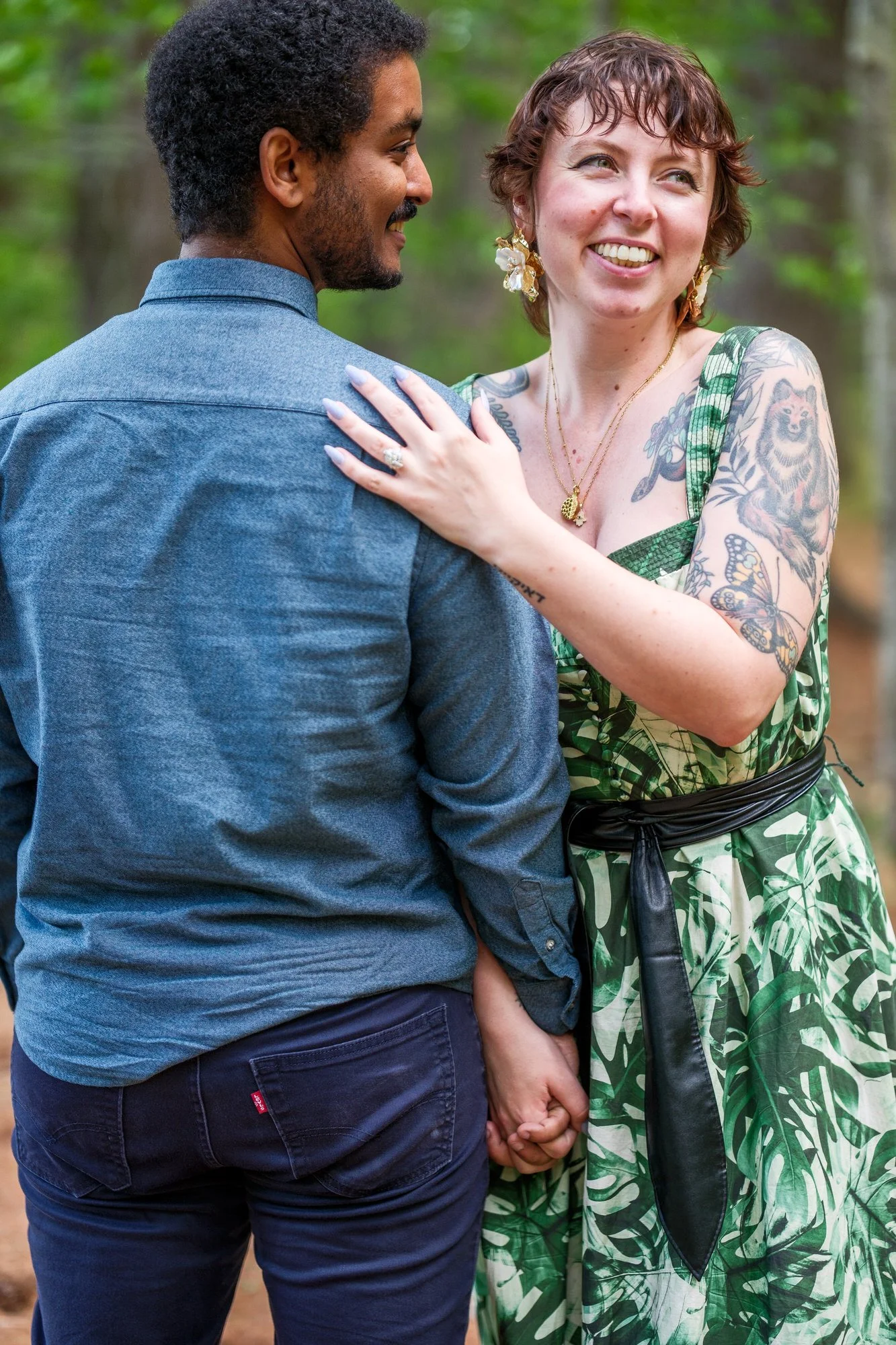 Couple holding hands and smiling after a surprise proposal in Medford Massachusetts