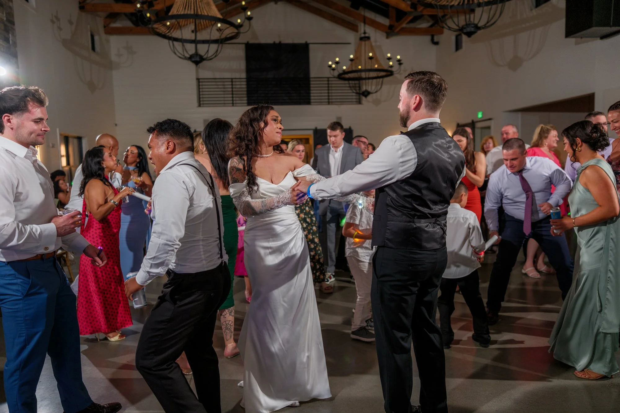 Wedding guests dancing with light sticks at Hyla Brook Estate reception