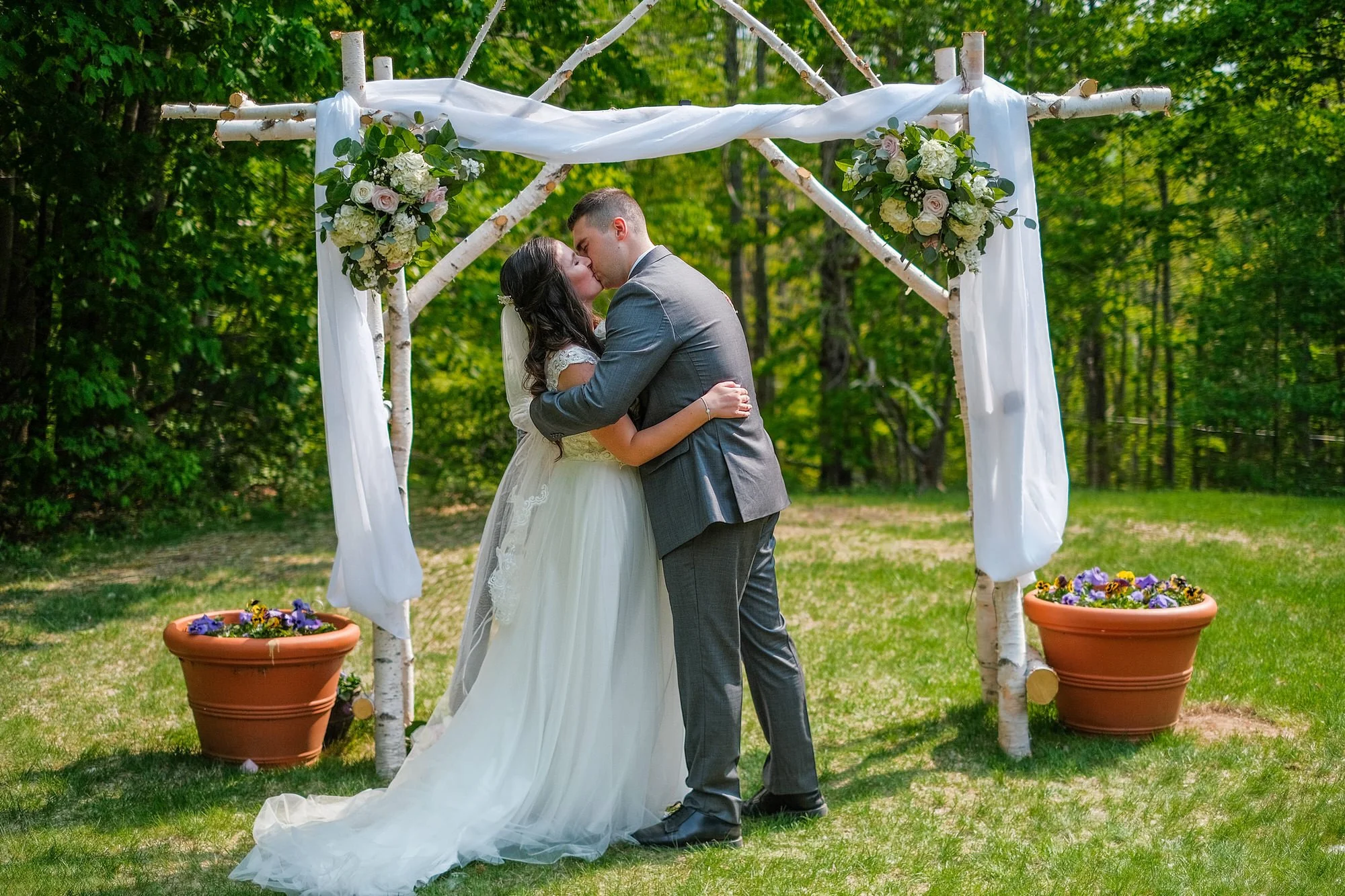 Bride and groom share their first kiss after their elopement at the Christmas Farm Inn