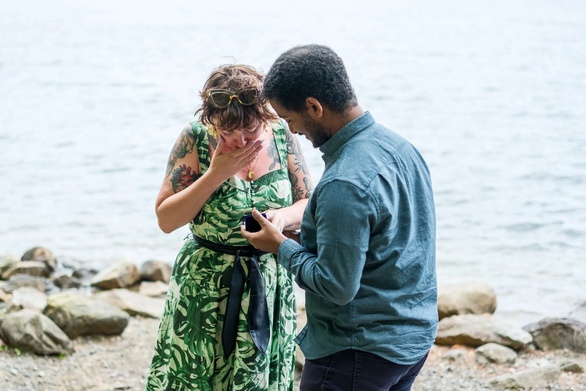 Emotional engagement moment as couple looks at the ring after a Middlesex Fells proposal