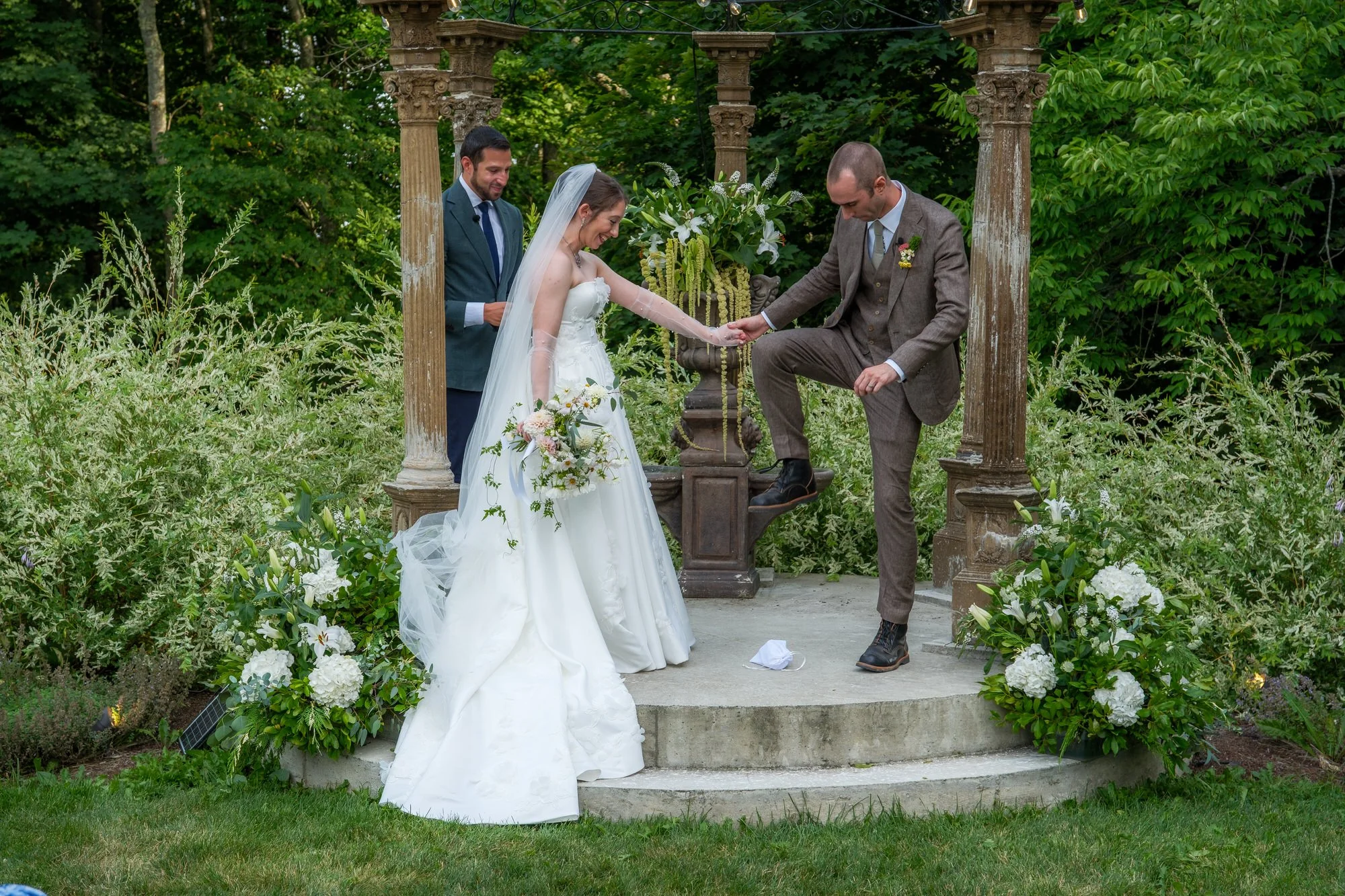 Bride and groom holding hands on the ceremony steps