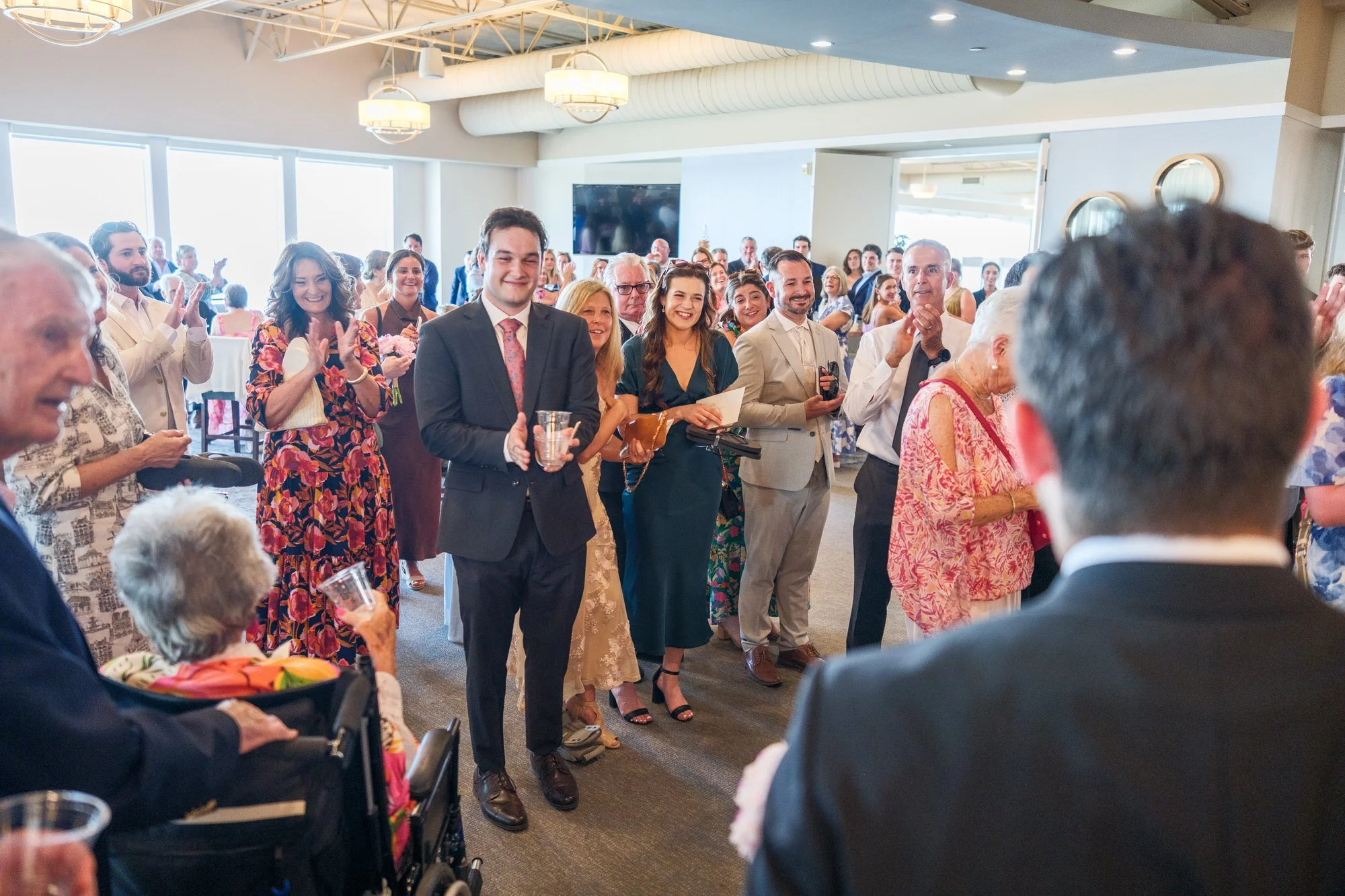 Wedding guests gathered indoors at Blue Ocean Event Center in Salisbury, MA.