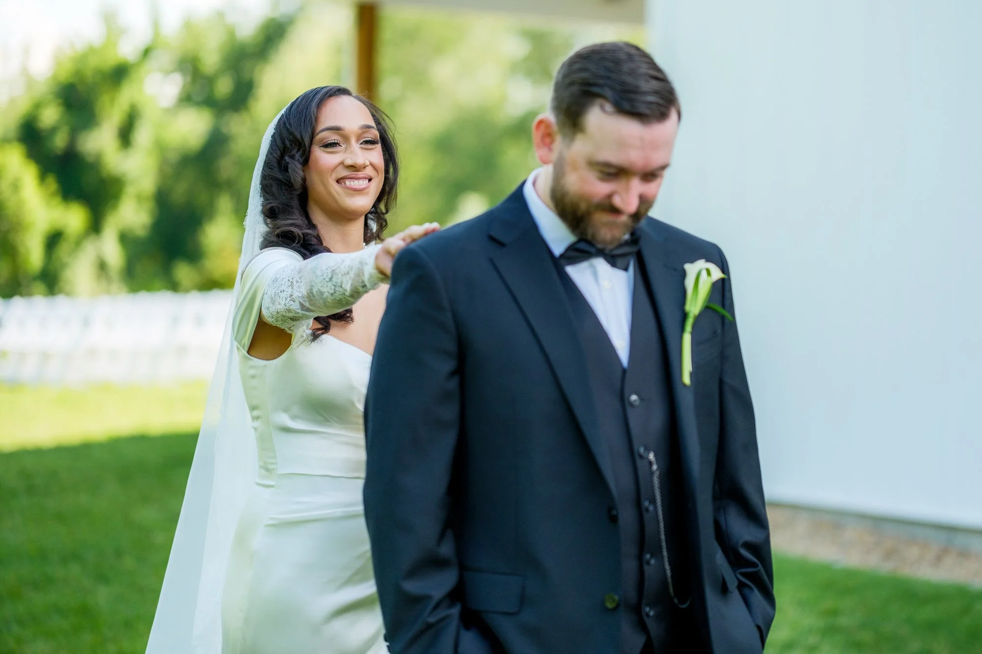 Bride reaches for groom during first look at Hyla Brook Estate
