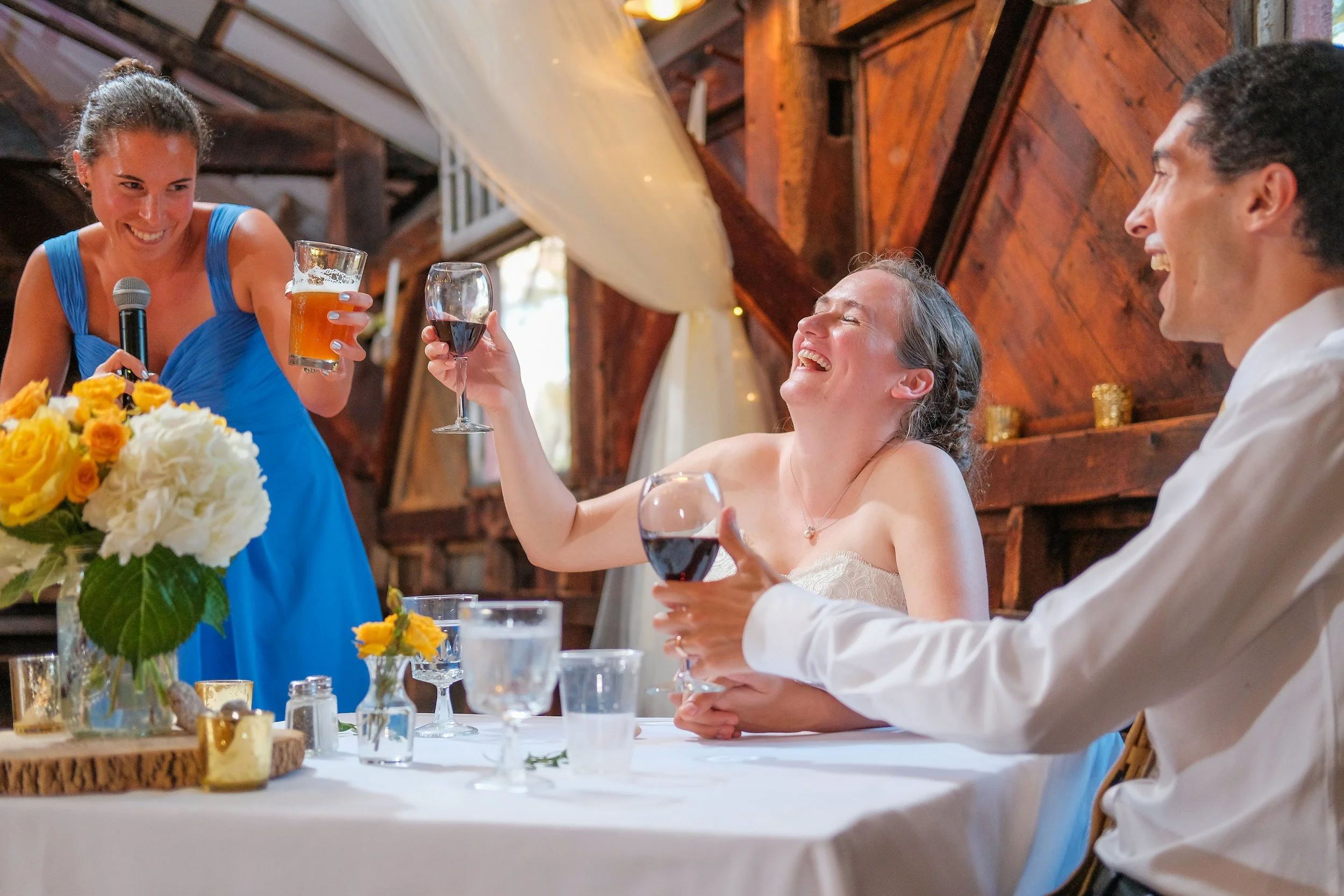 vermont-barn-wedding-toast-laughing-bride-reception.jpg