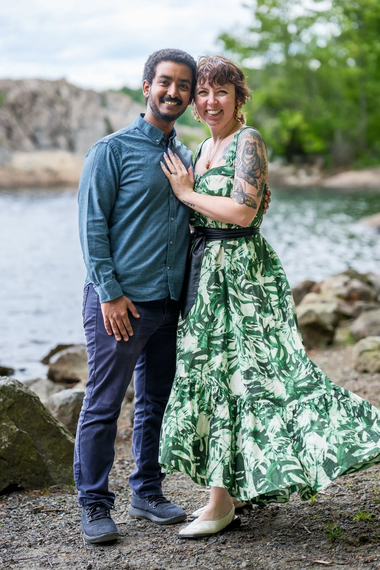 Newly engaged couple posing by the lake at Middlesex Fells Reservation in Medford