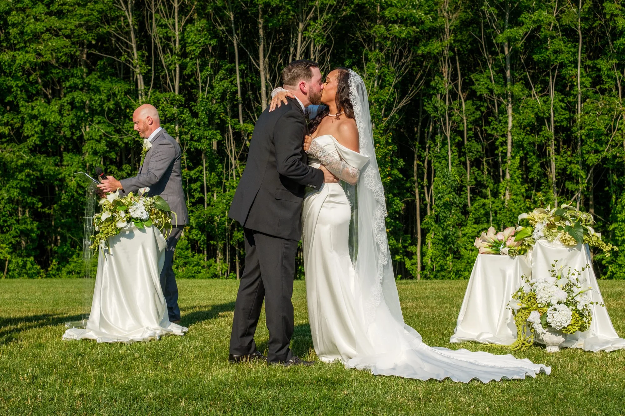 Bride and groom first kiss during their Hyla Brook Estate wedding ceremony