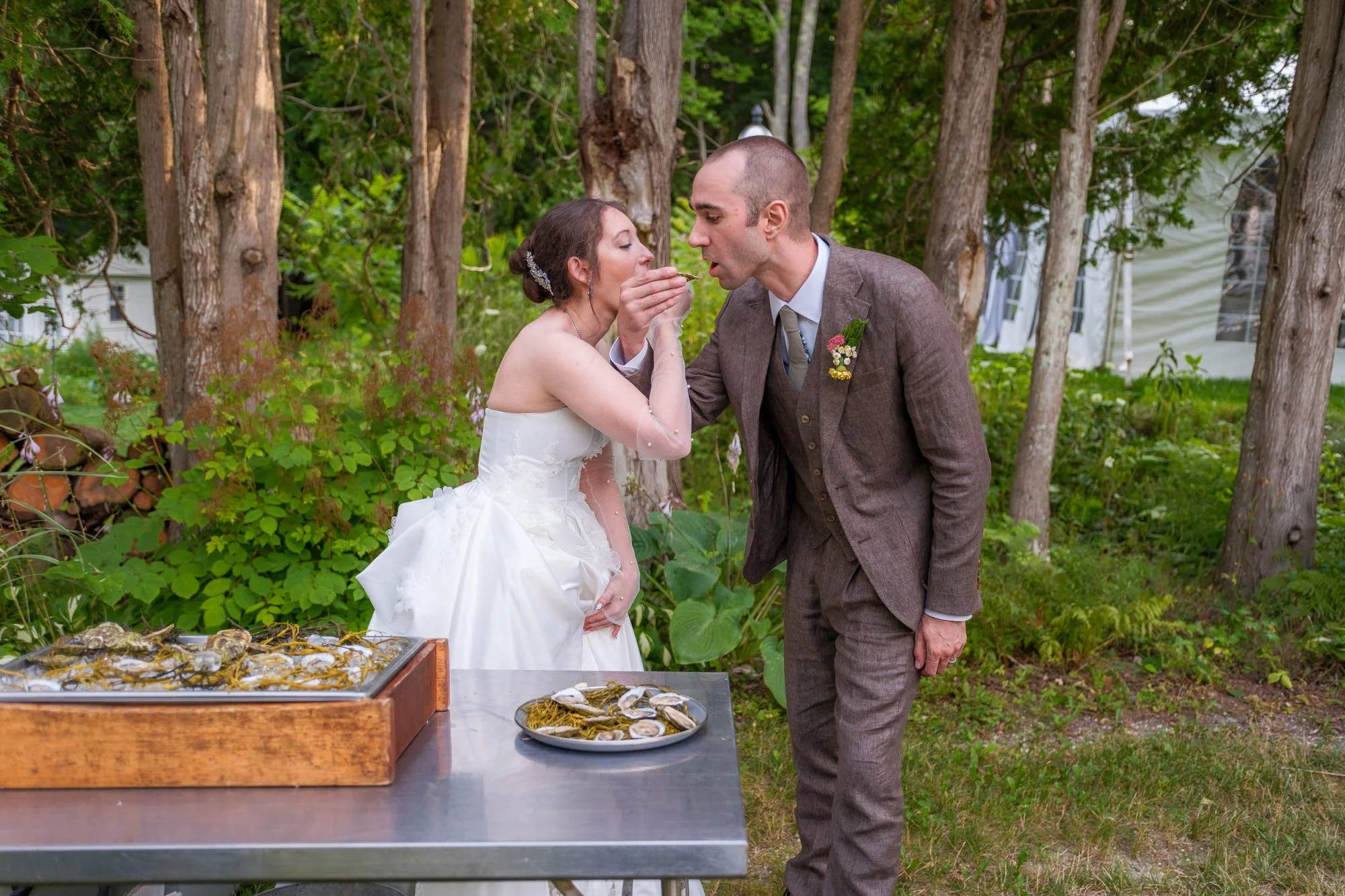 Bride and groom sharing a bite during cocktail hour