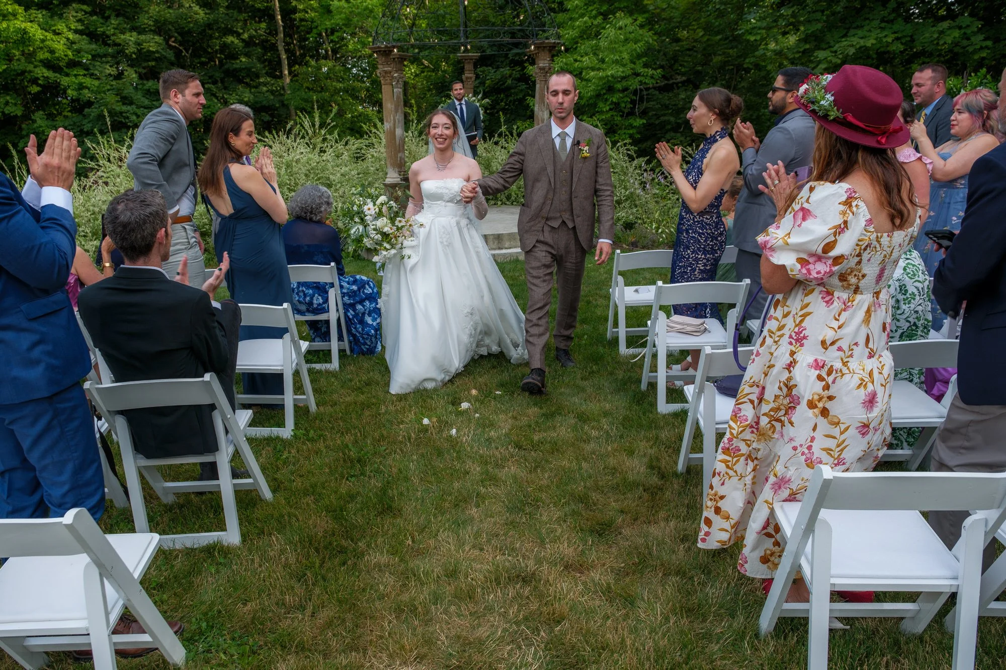 Newlyweds recessing down the aisle after their garden ceremony