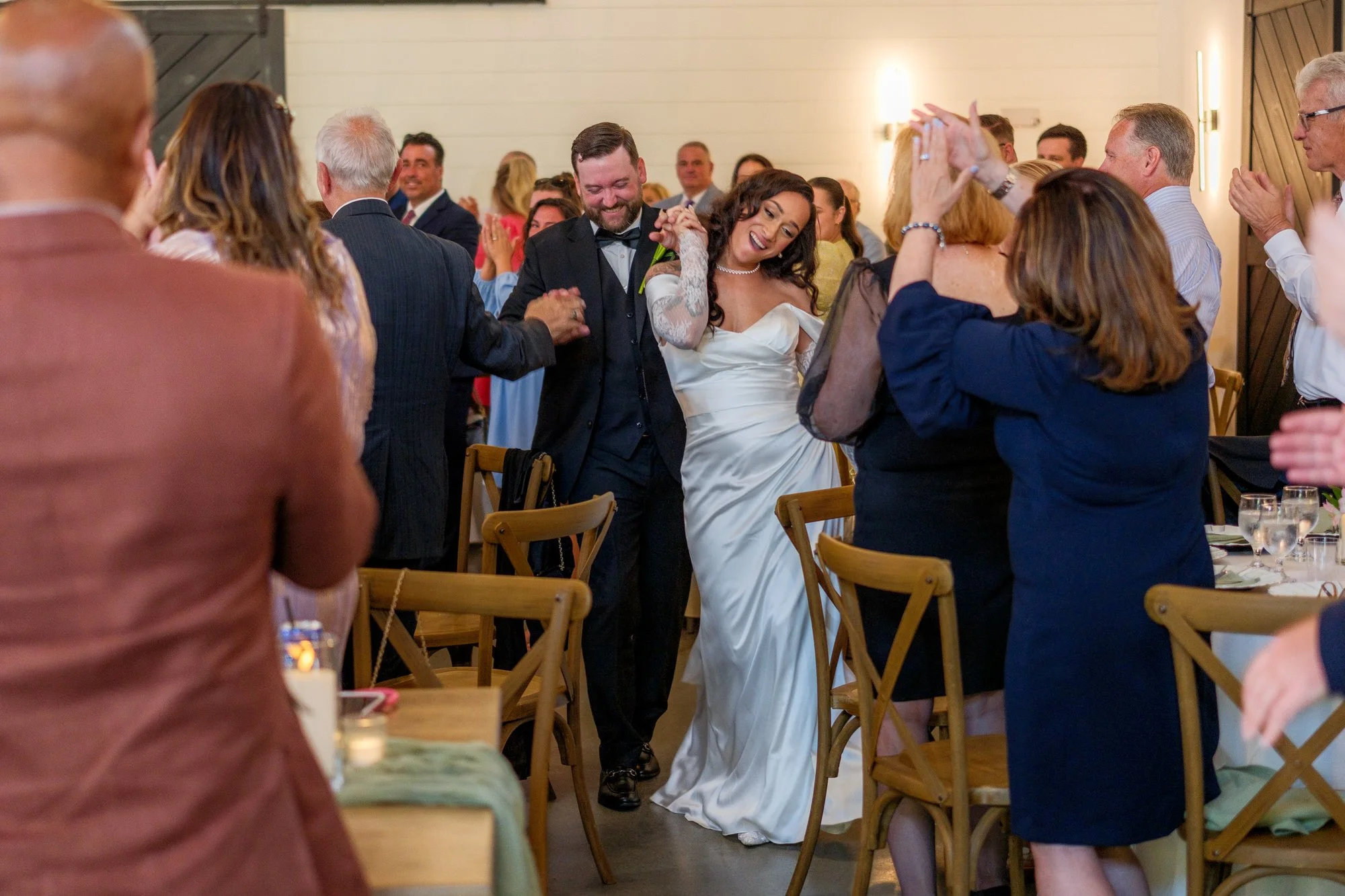 Guests celebrating newlyweds during indoor reception at Hyla Brook Estate