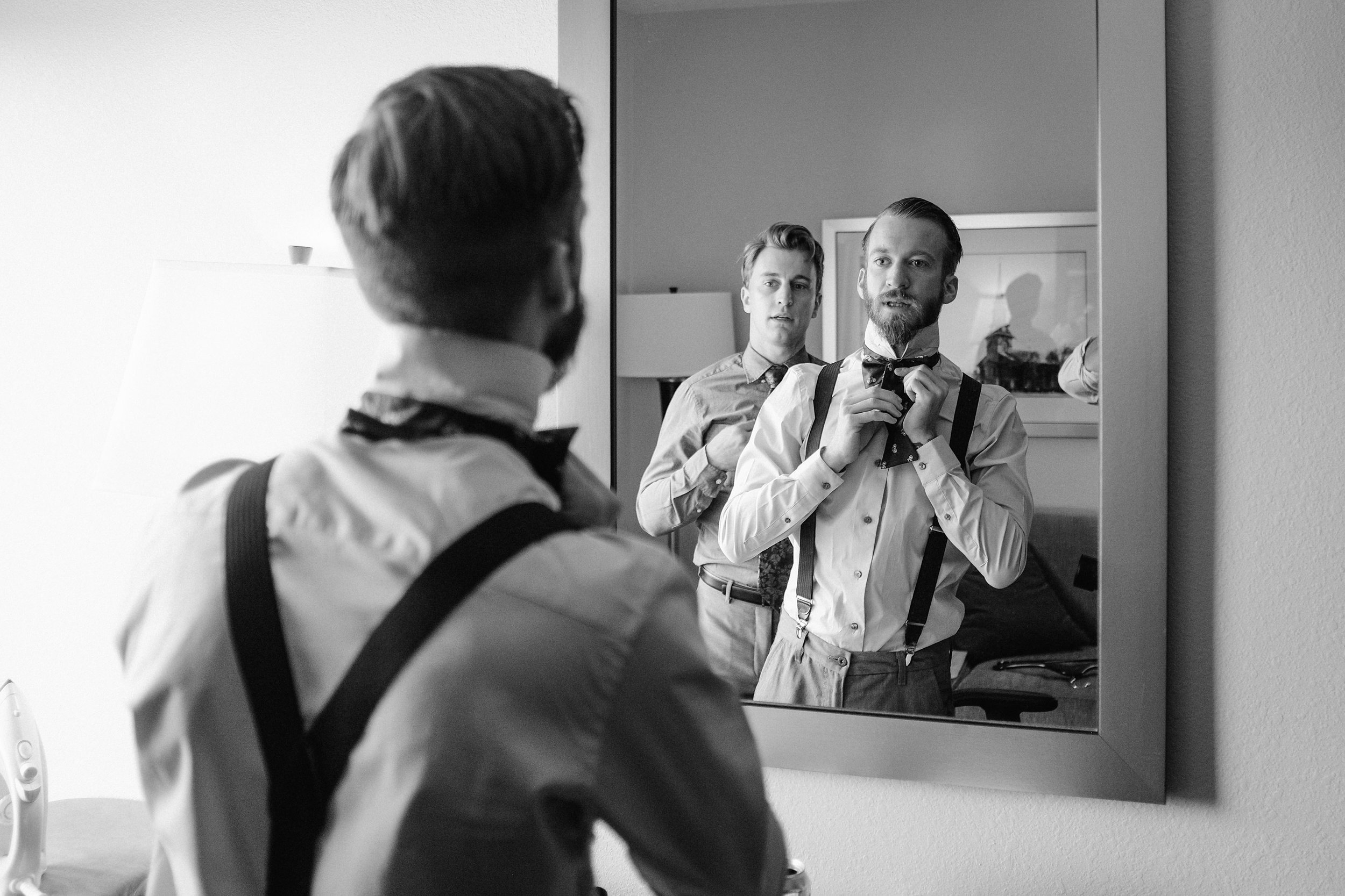 groom-getting-ready-bowtie-mirror-black-and-white-nh-wedding.jpg