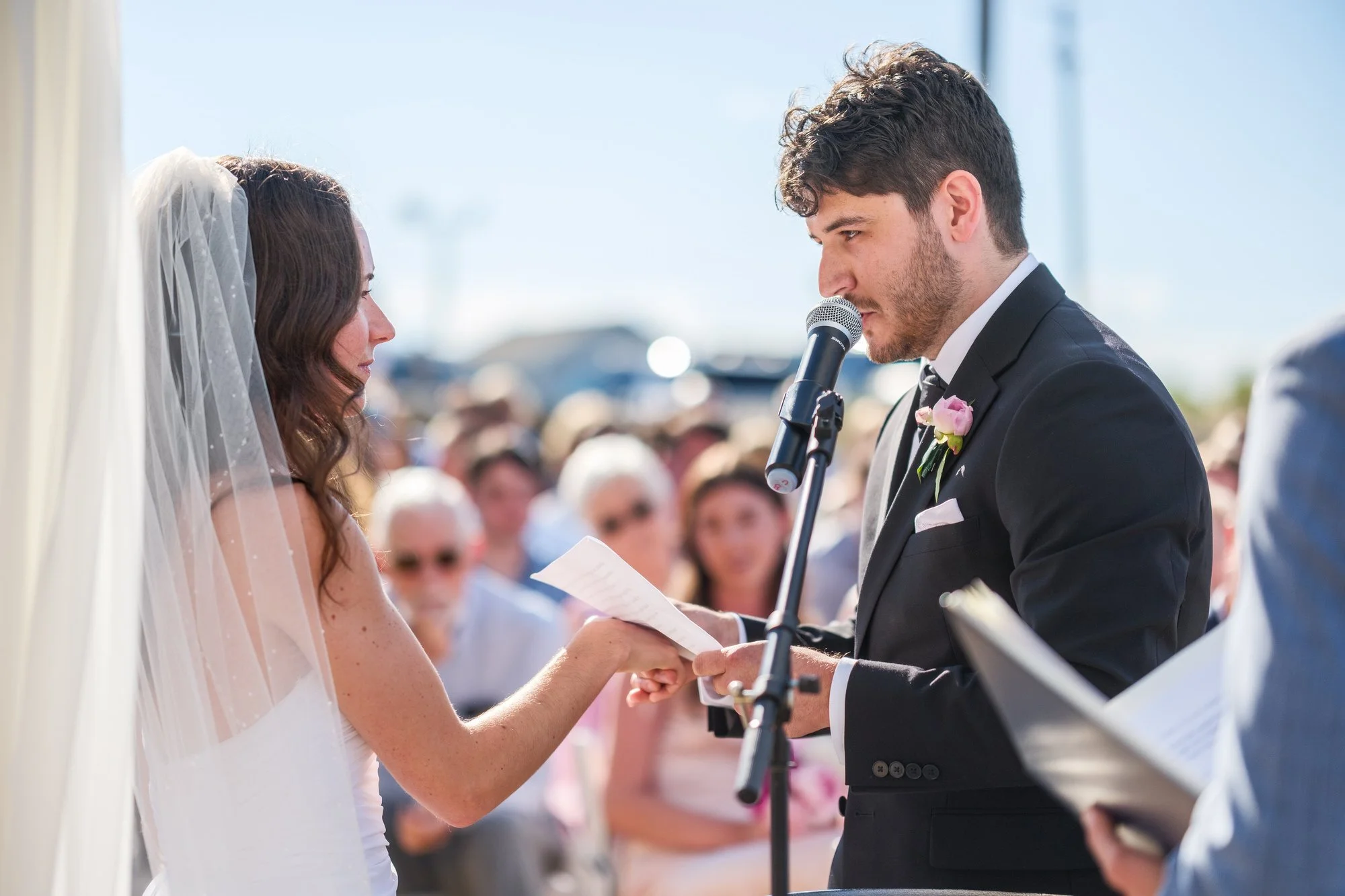 Groom reading vows to his bride during a Blue Ocean Event Center beach wedding ceremony.