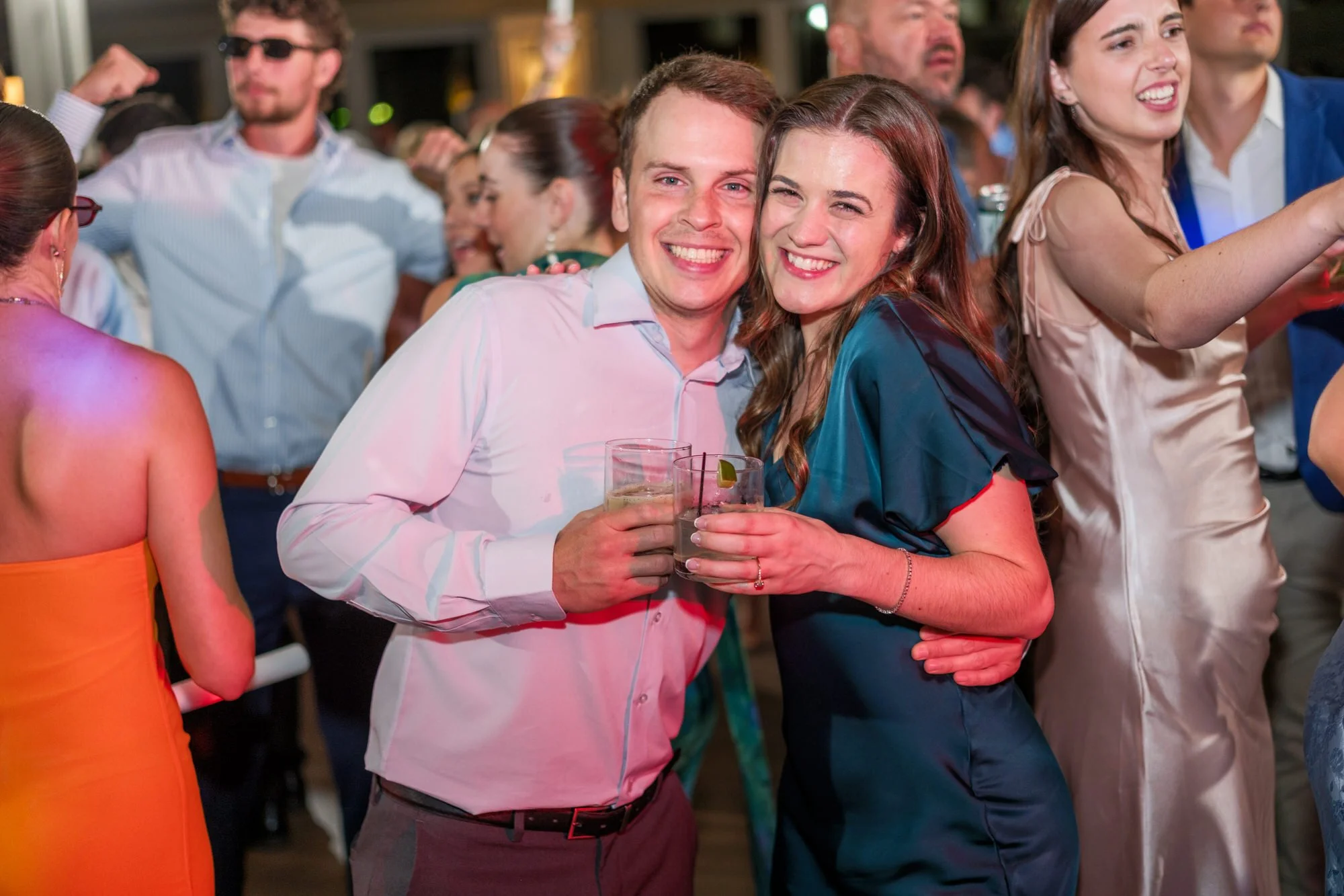 Wedding guests smiling for the camera on the Blue Ocean Event Center dance floor.