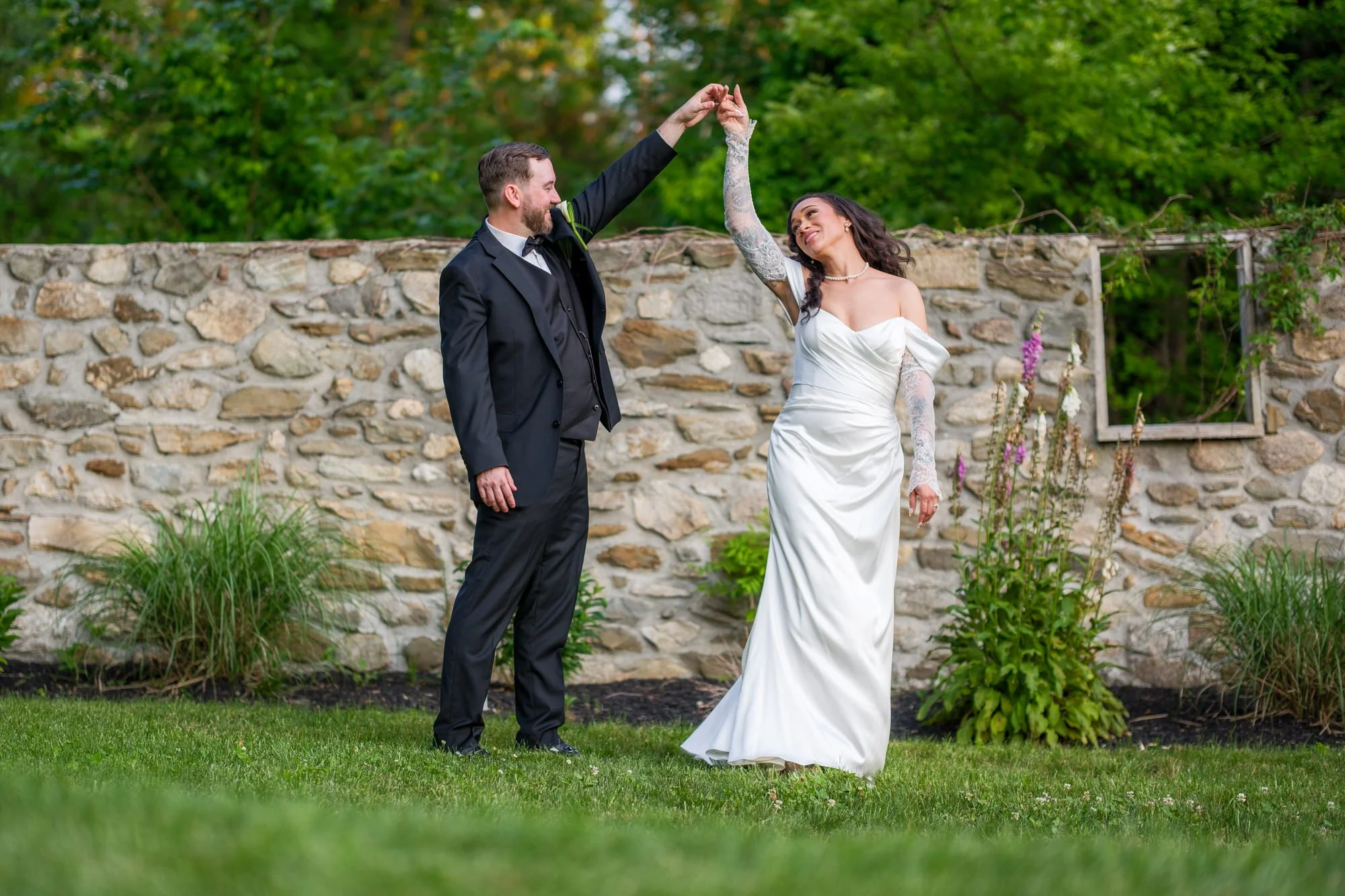 Groom twirling bride for portraits at Hyla Brook Estate