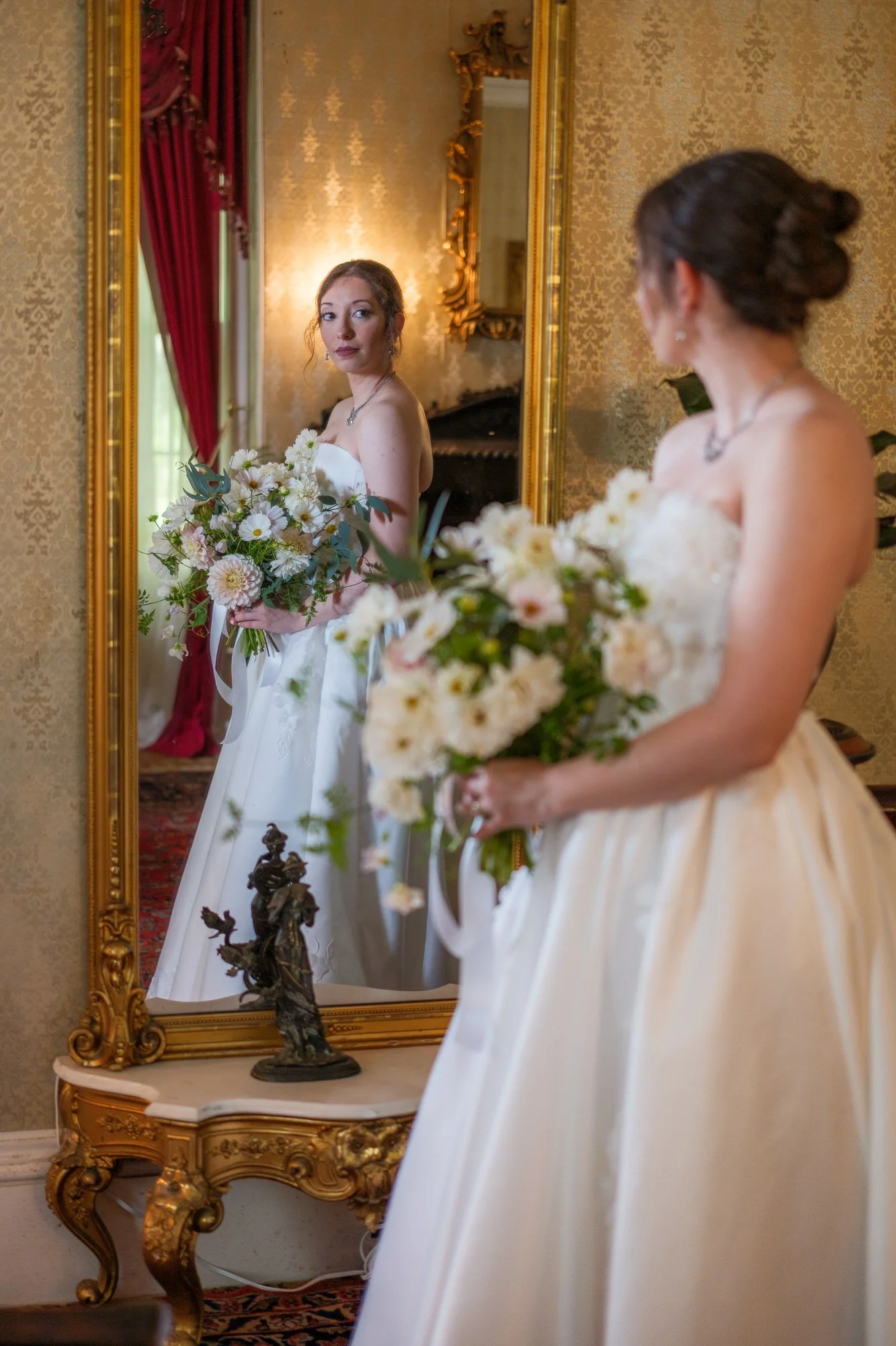 Bride holding a white floral bouquet inside Belvedere House