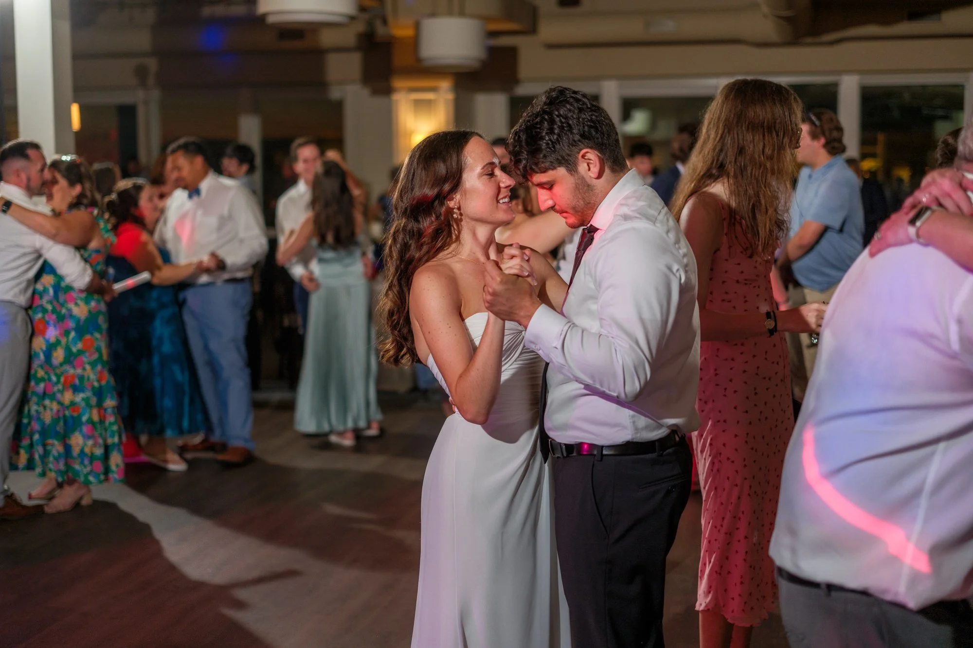 Bride and groom slow dancing together during their Blue Ocean Event Center reception.
