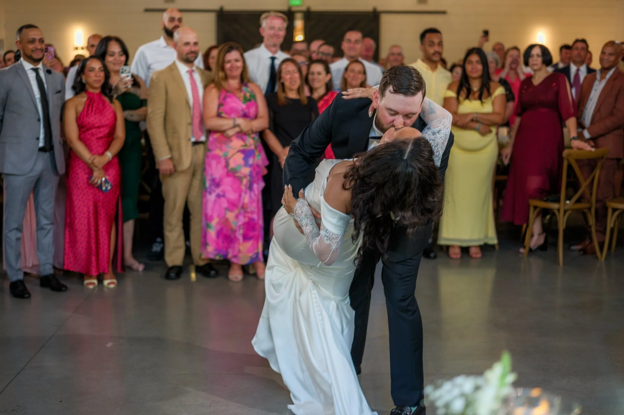 Groom dipping bride during first dance at Hyla Brook Estate wedding reception