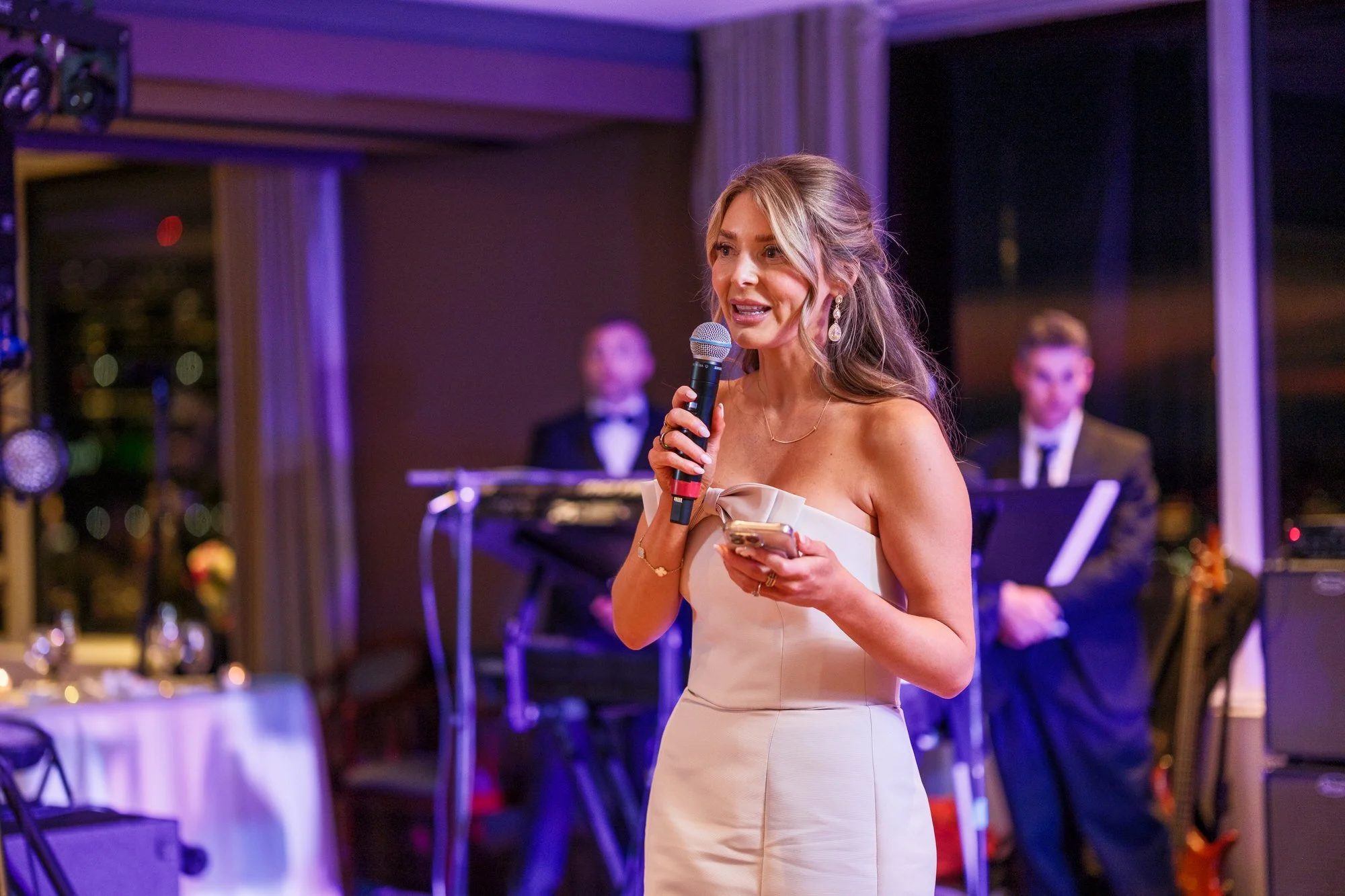 Maid of honor delivering a speech with microphone at the UMass Club Boston Jewish wedding reception