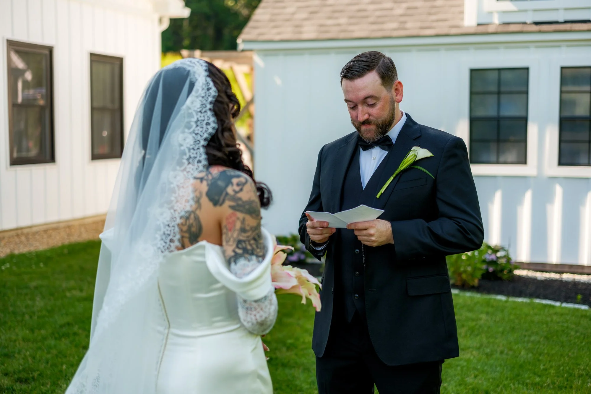Bride and groom reading private vows during their Hyla Brook Estate wedding