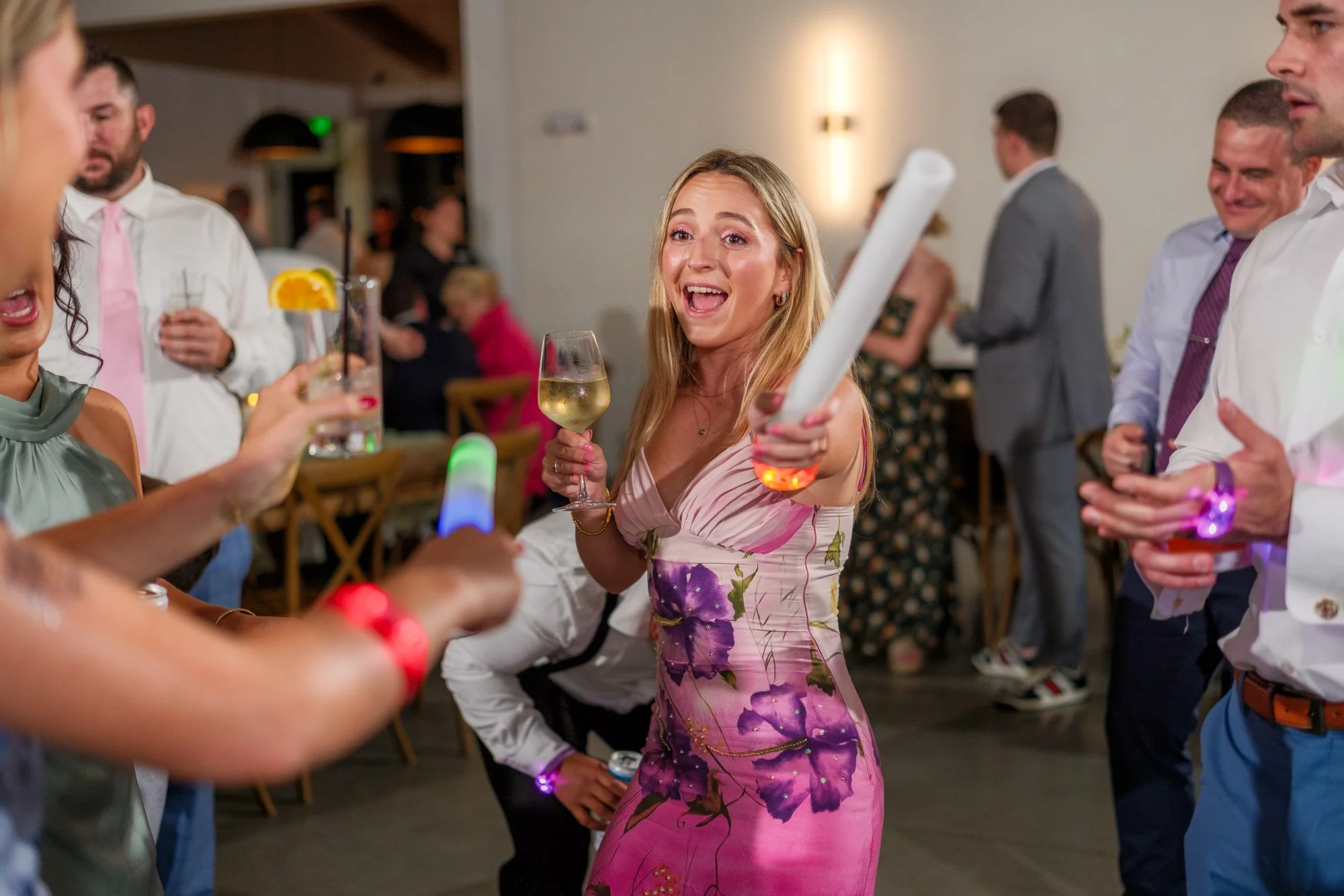 Guest dancing with glow stick at Hyla Brook Estate wedding reception