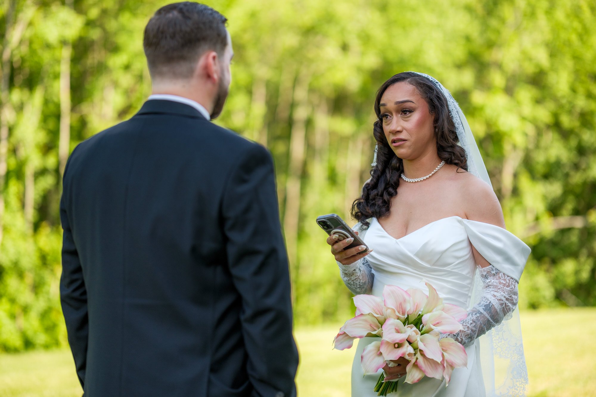 Bride reading vows to groom during first look at Hyla Brook Estate