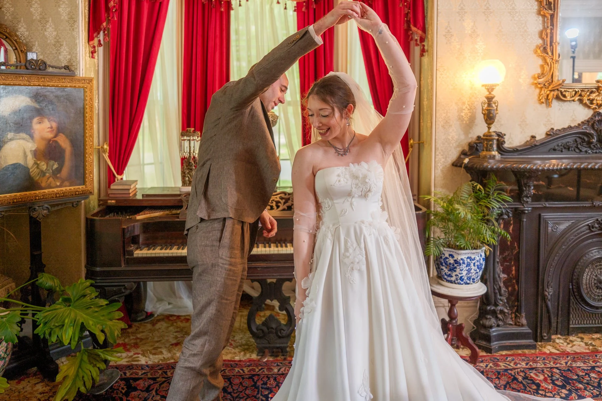 Groom twirling the bride during their indoor first look