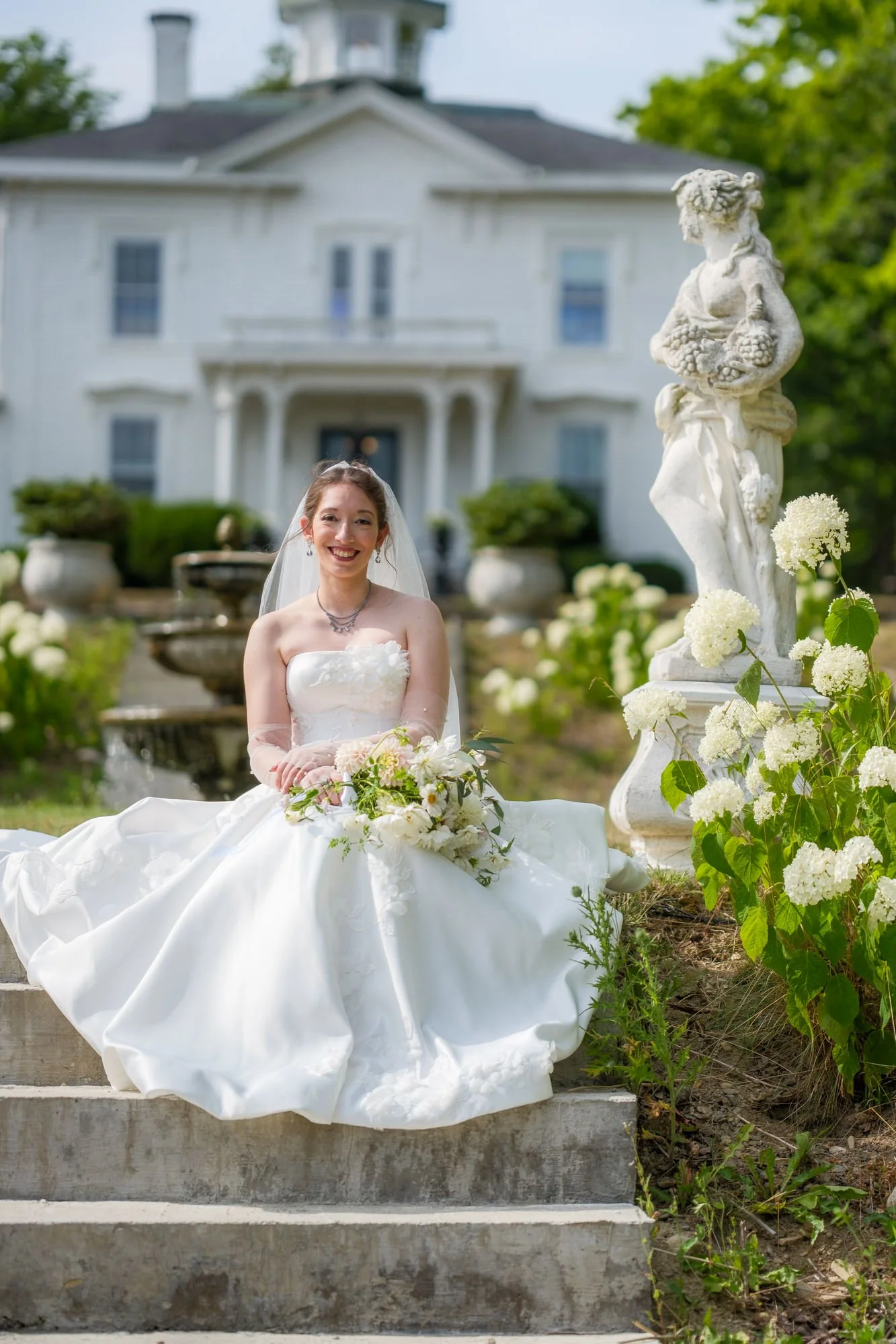 Bride portrait on garden steps with Belvedere House in the background