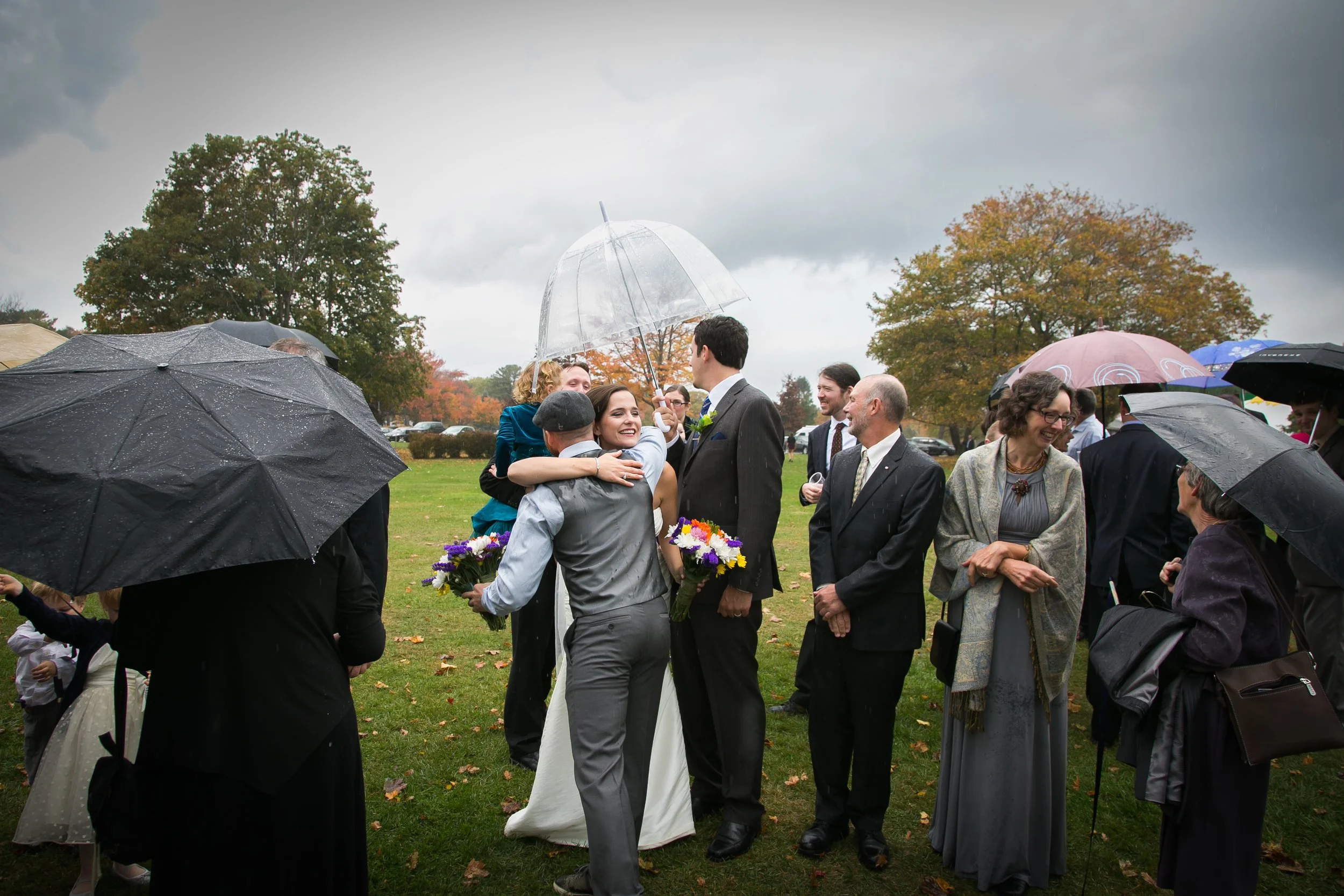 rainy-wedding-day-couple-hug-umbrellas-new-england-photographer.jpg