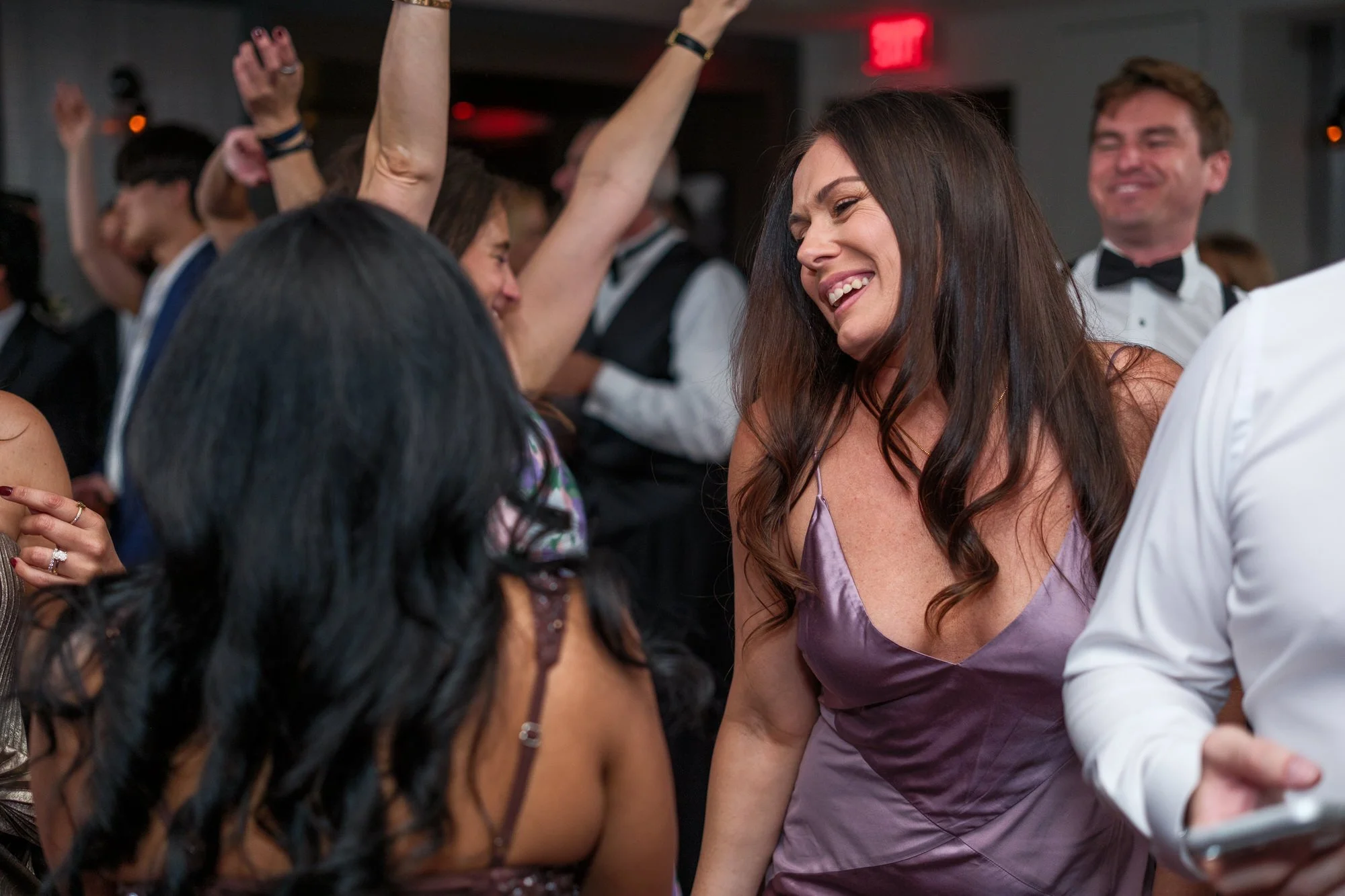 Close-up of guests dancing at the UMass Club Boston Jewish wedding reception