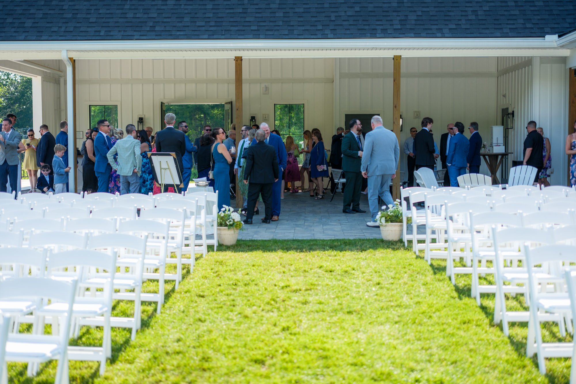 Guests arriving for an outdoor Hyla Brook Estate wedding ceremony
