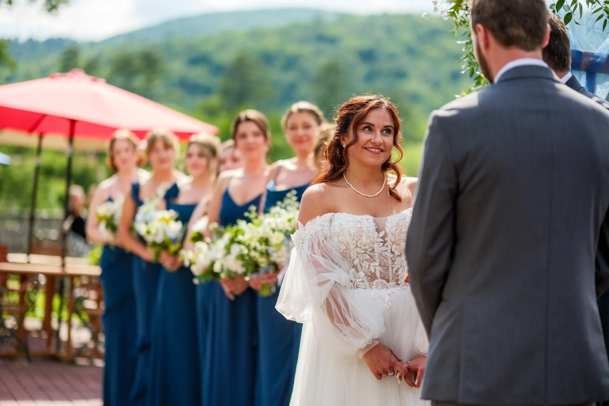 Bride and bridesmaids during lakeside ceremony at Lake Morey Resort in Fairlee