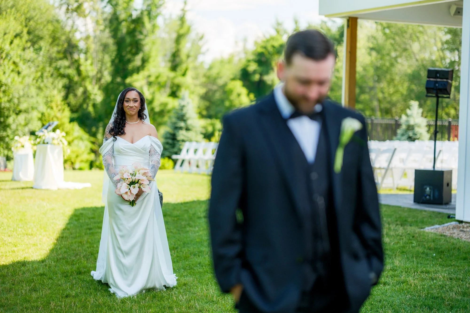 Bride walking toward groom for first look at Hyla Brook Estate