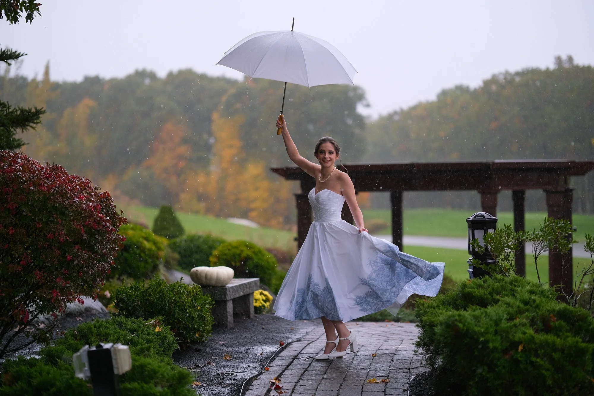 atkinson-country-club-nh-bride-dancing-in-rain-umbrella.jpg