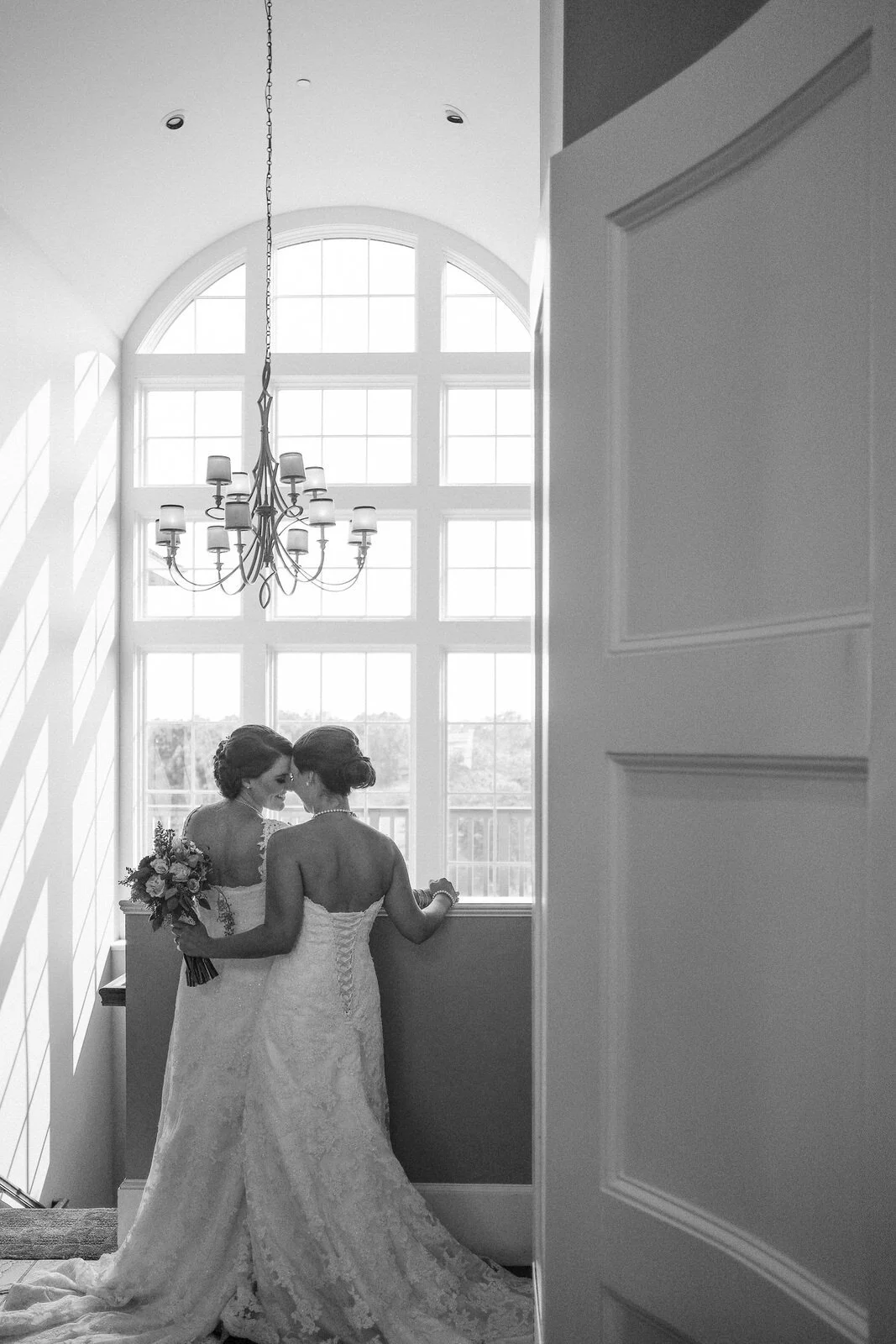 same-sex-wedding-brides-window-silhouette-black-and-white-nh.jpeg