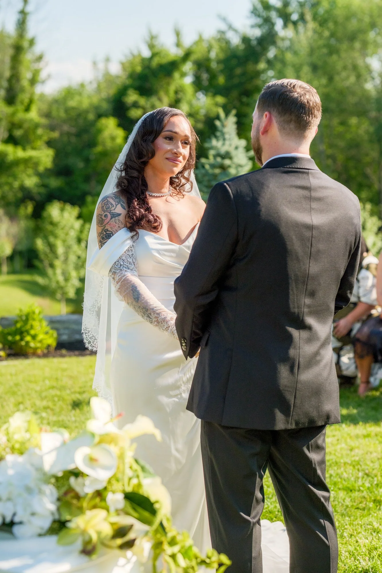 Bride and groom exchanging vows outdoors at Hyla Brook Estate