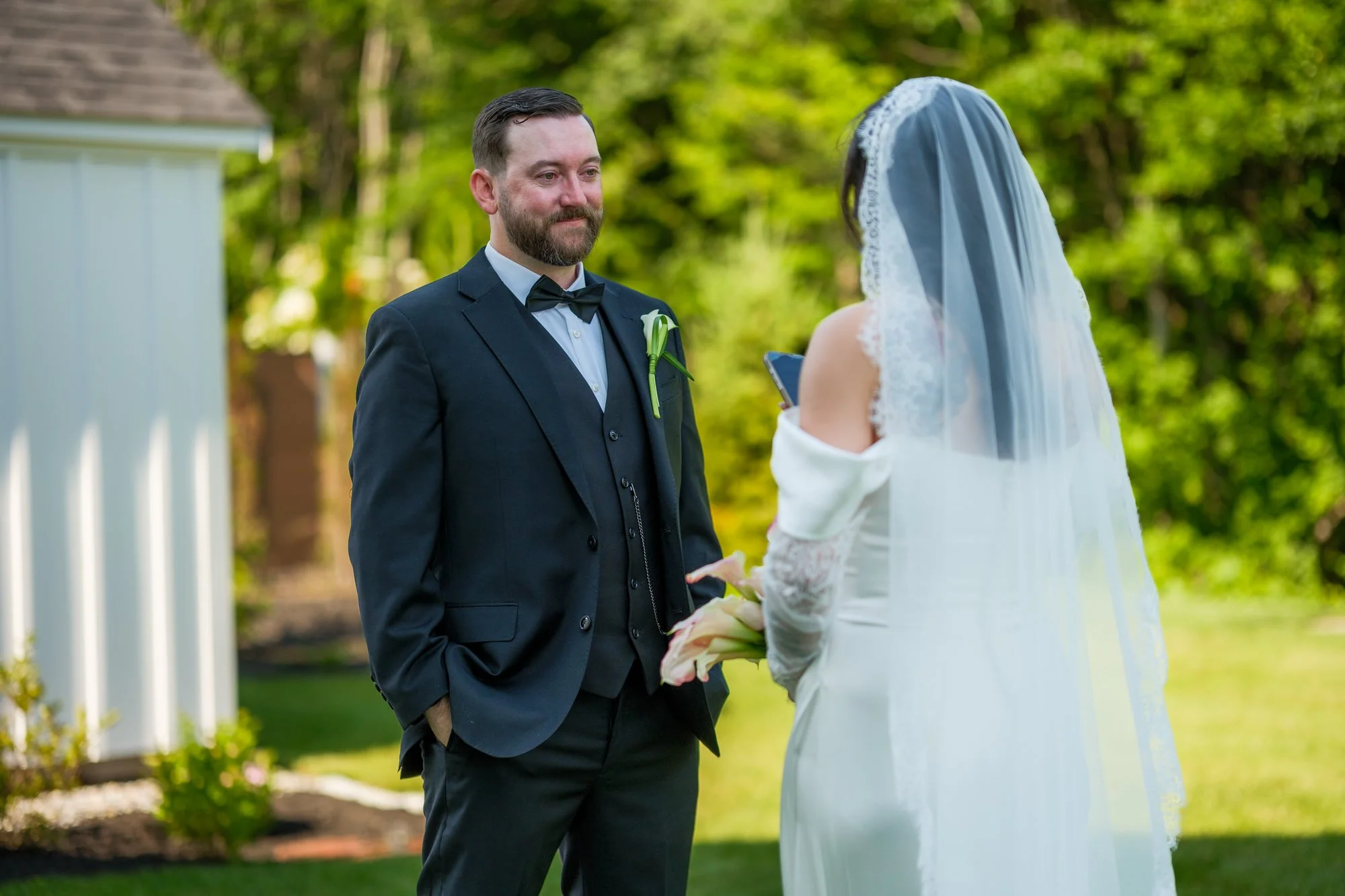 Groom smiling at bride during private vows at Hyla Brook Estate