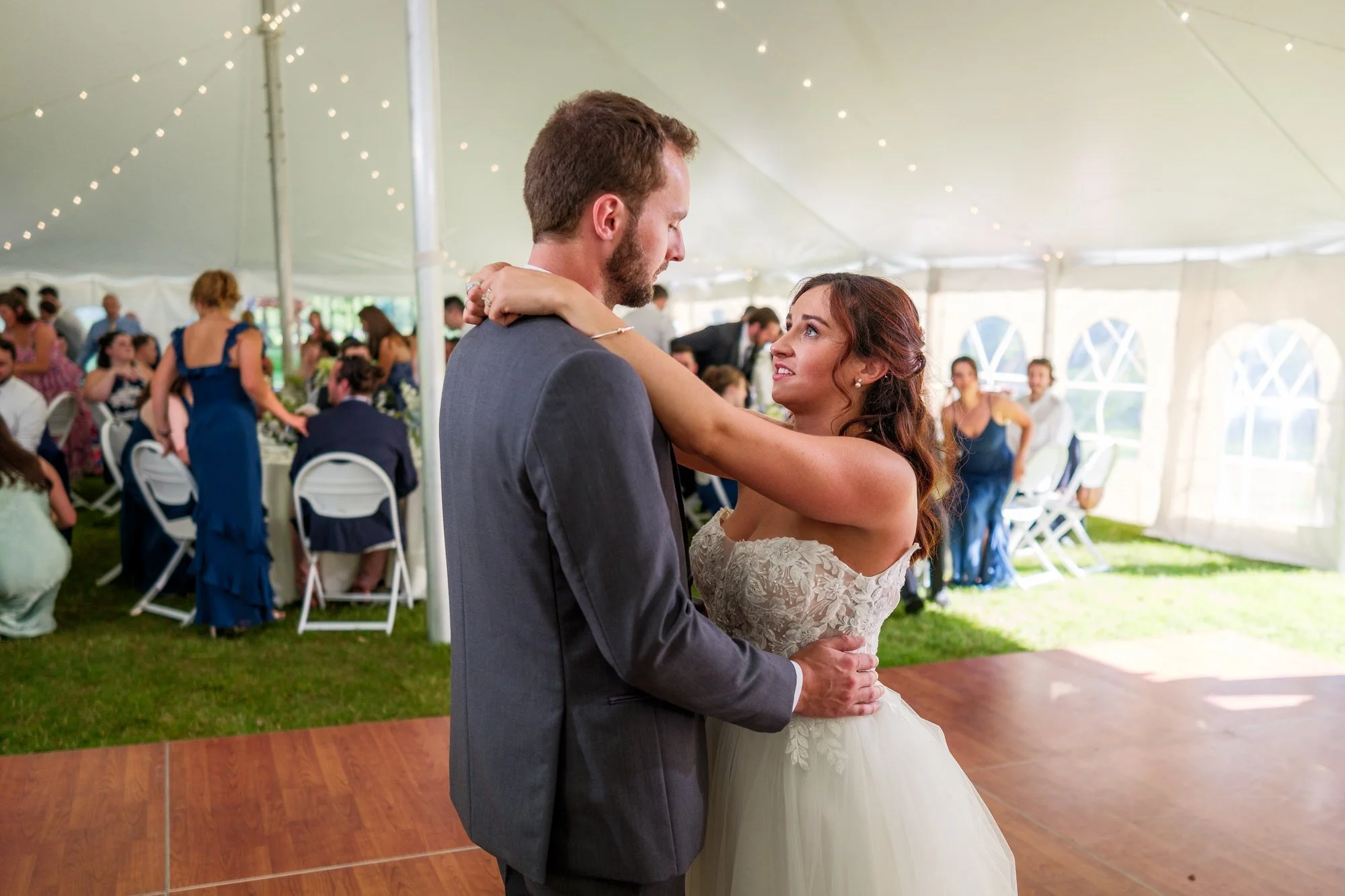 Bride and groom first dance under the tent at Lake Morey Resort wedding reception