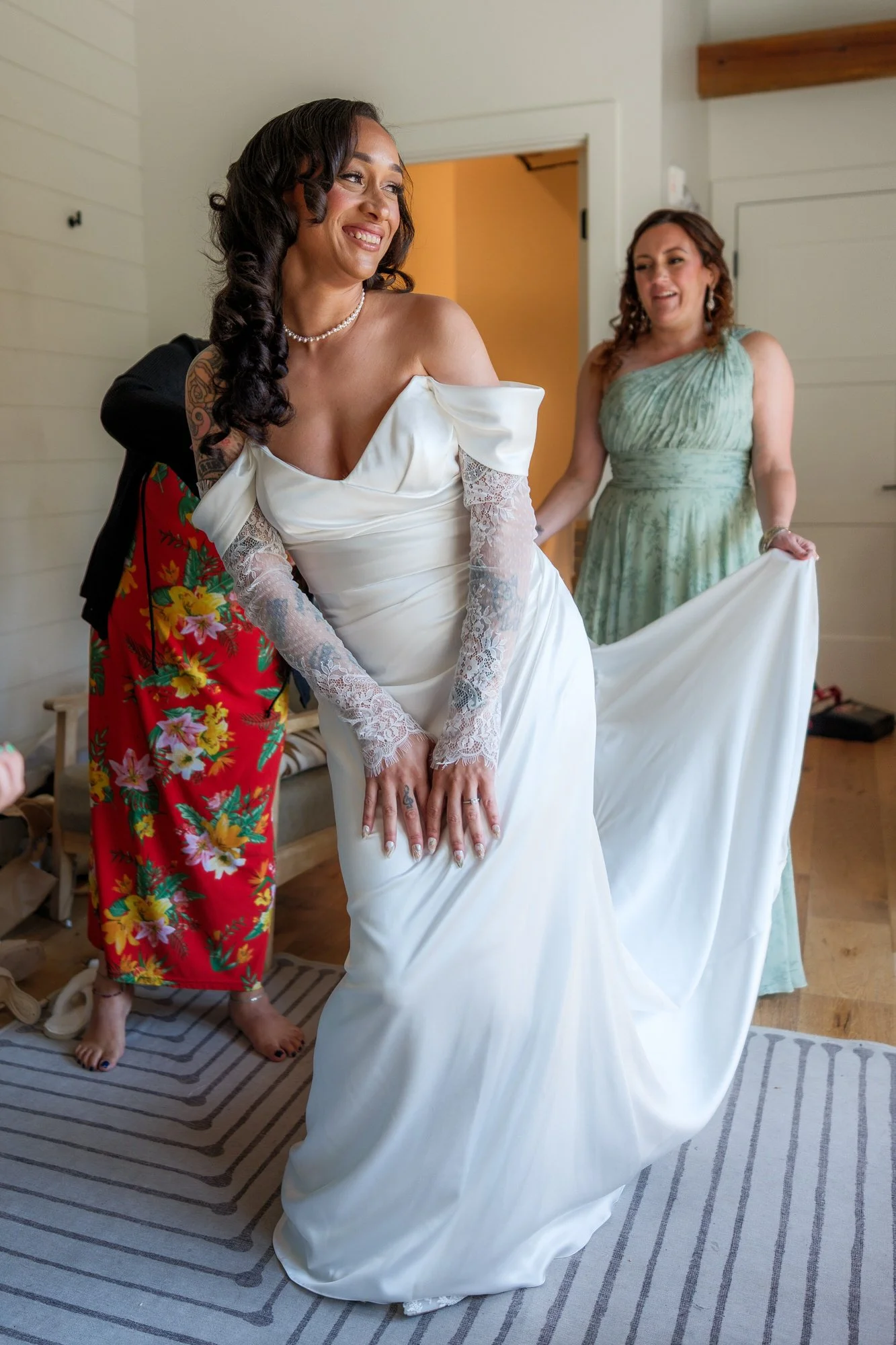 Bride standing with bridesmaids while getting ready for her Hyla Brook Estate wedding