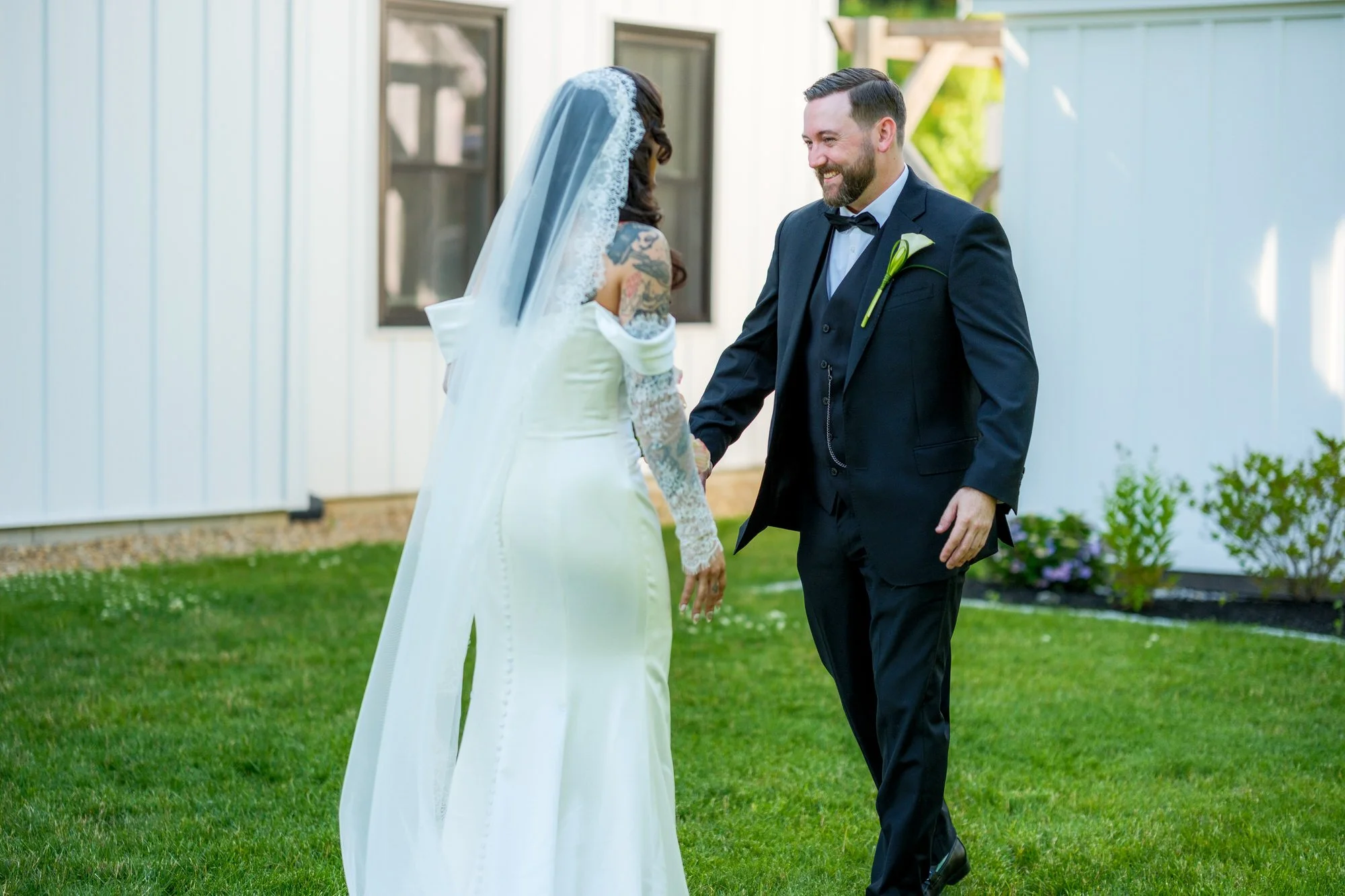 Bride and groom holding hands after their first look at Hyla Brook Estate