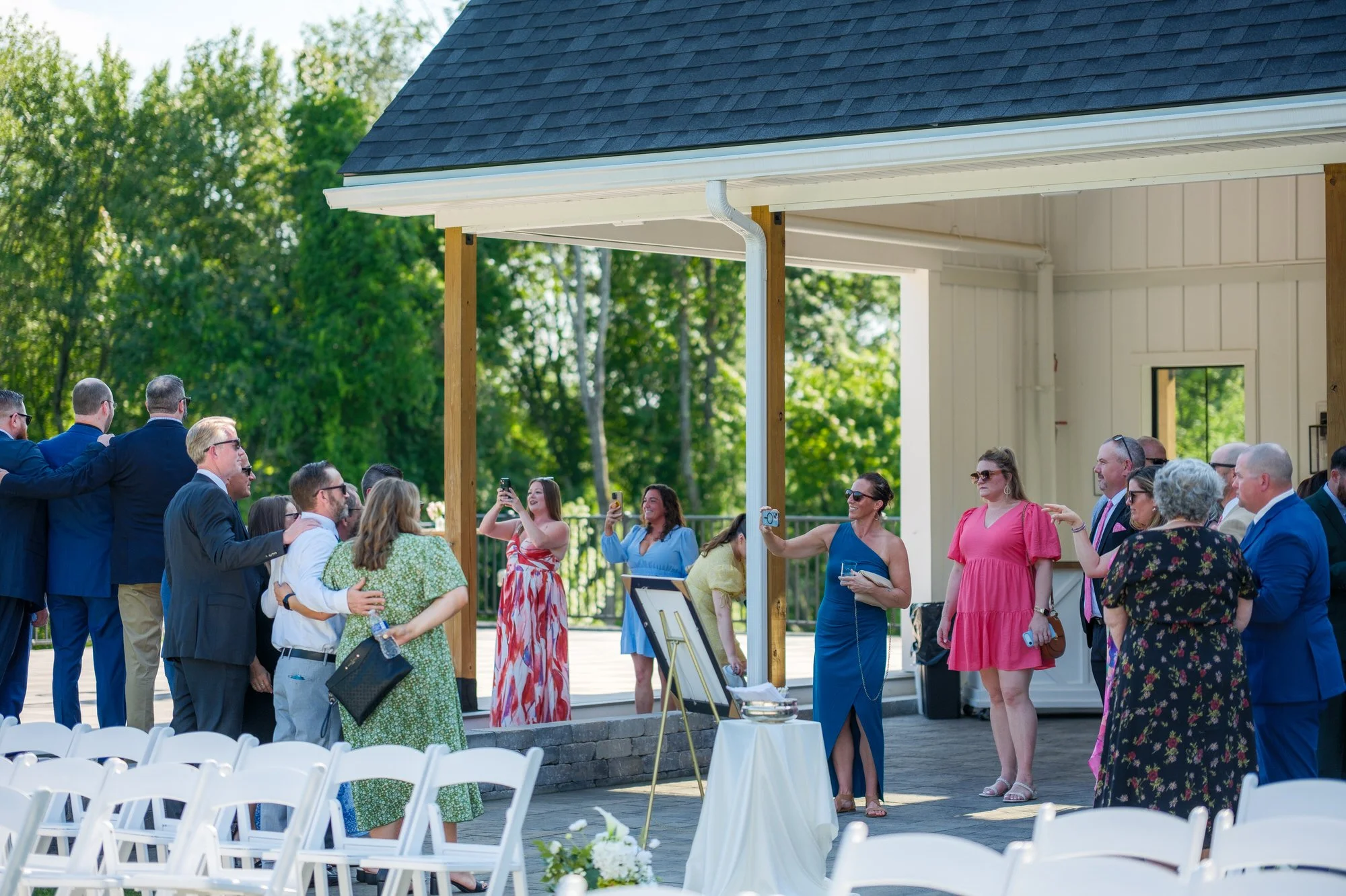 Wedding guests greeting each other before ceremony at Hyla Brook Estate