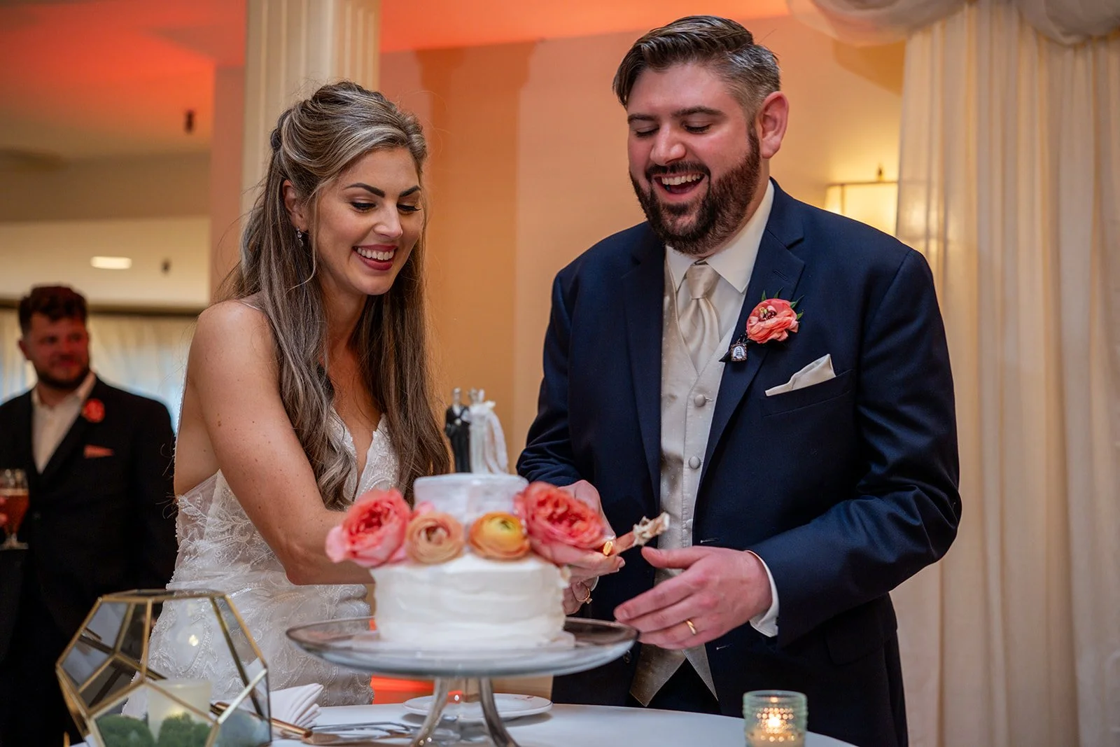 Bride and groom laughing during cake cutting at York Maine wedding reception