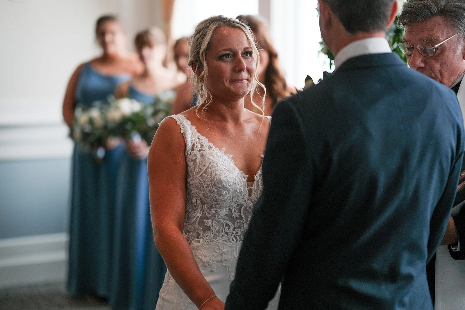 Close-up of bride with tears in her eyes during wedding ceremony at Blue Ocean Event Center, Salisbury Massachusetts
