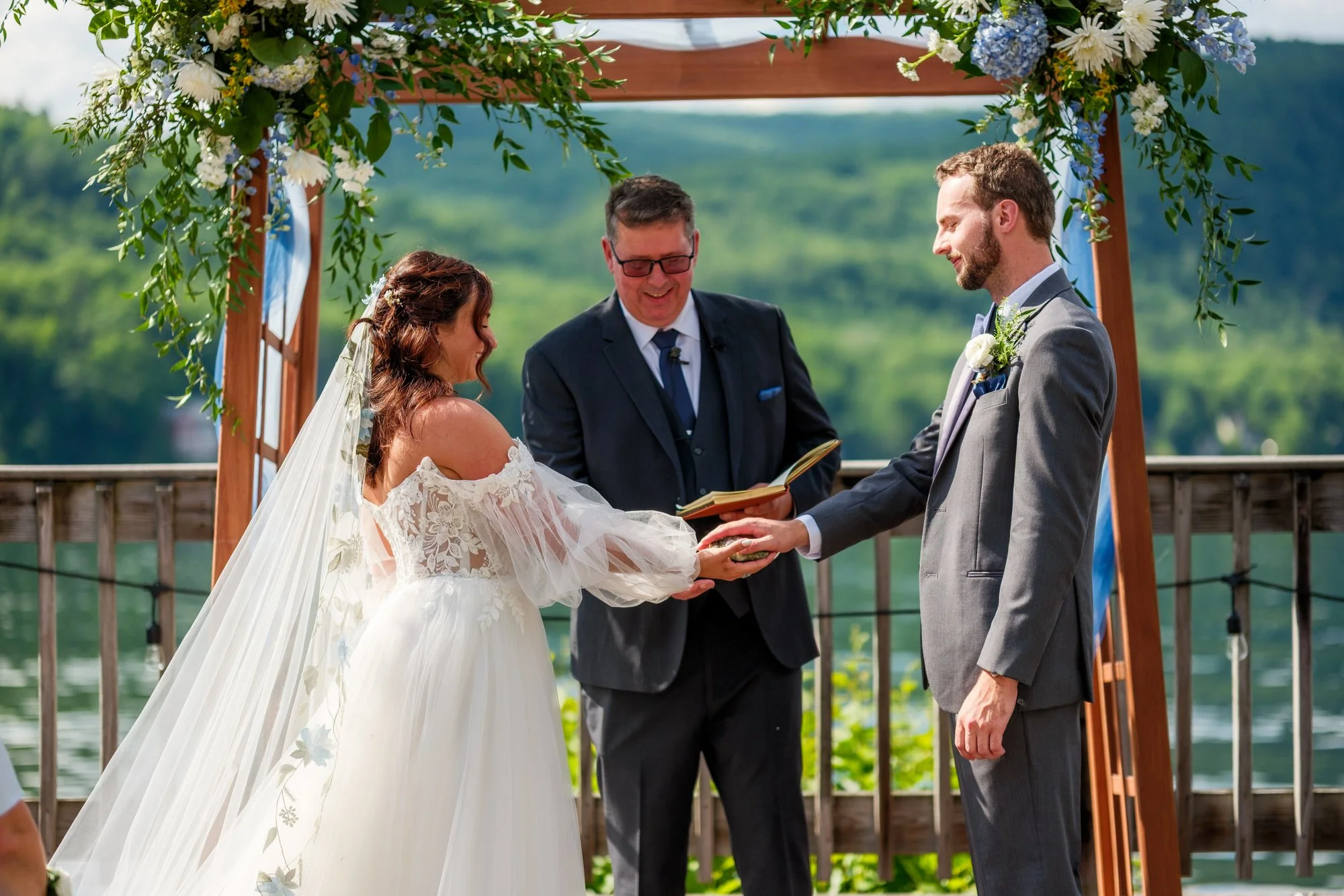 Bride and groom exchange rings at Lake Morey Resort wedding ceremony